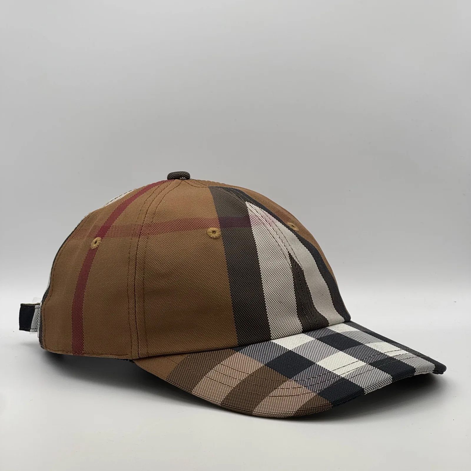 Brown check Burberry cap, side profile.