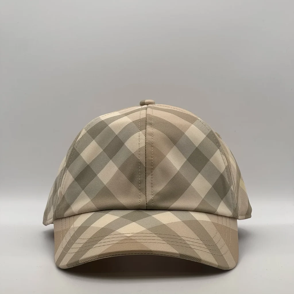 Pale beige check Burberry cap, three-quarter front-left view.