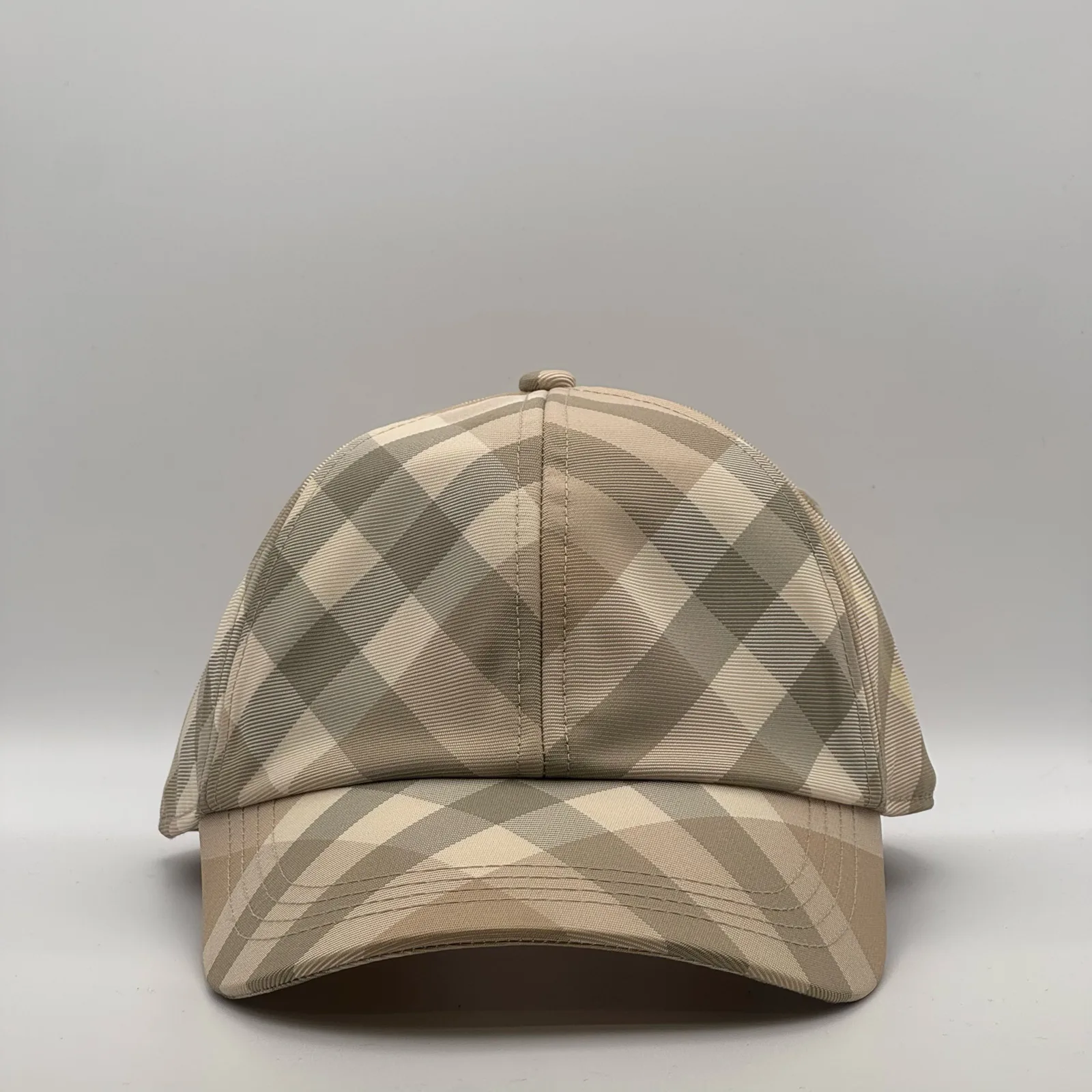 Pale beige check Burberry cap, three-quarter front-left view.