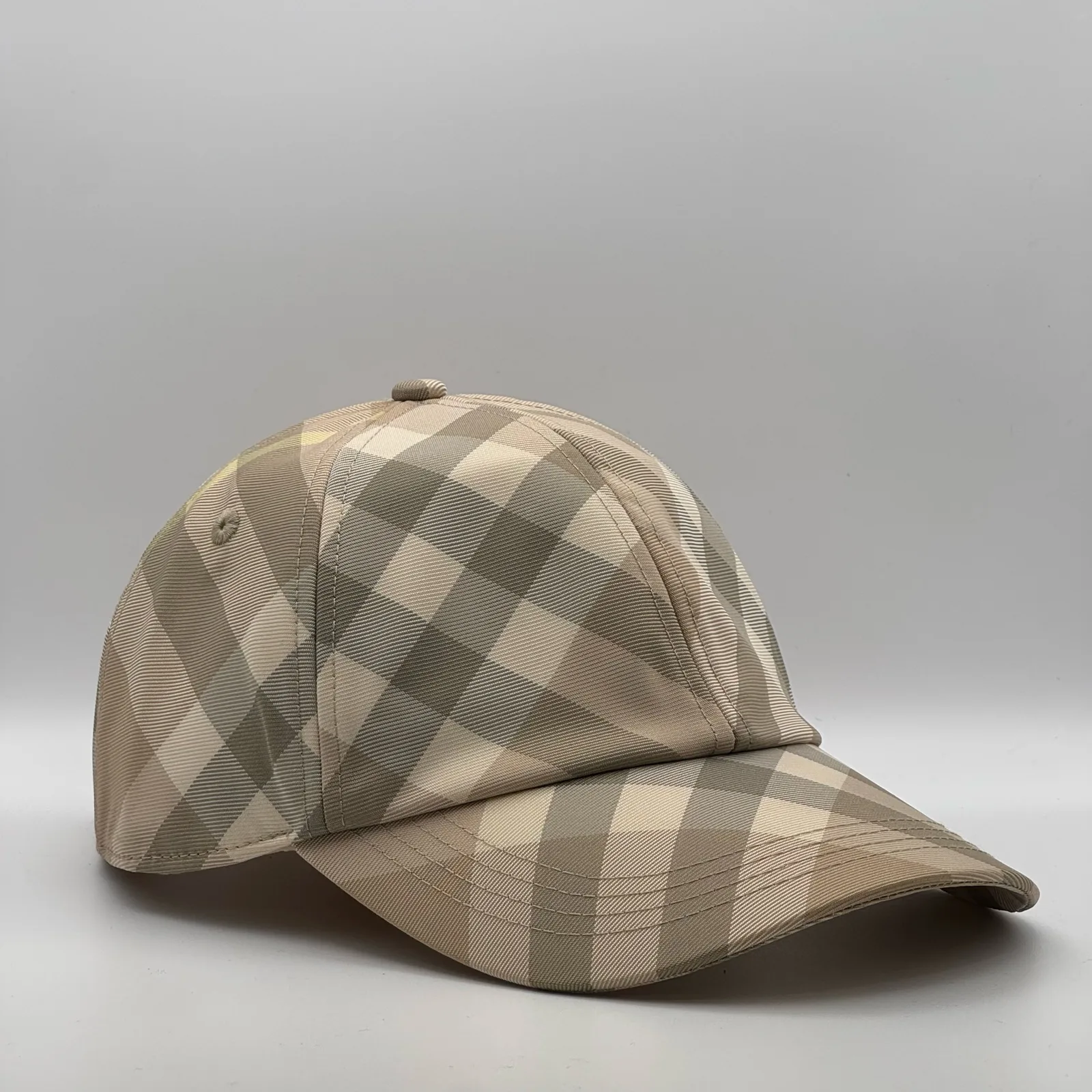 Pale beige check Burberry cap, side profile.