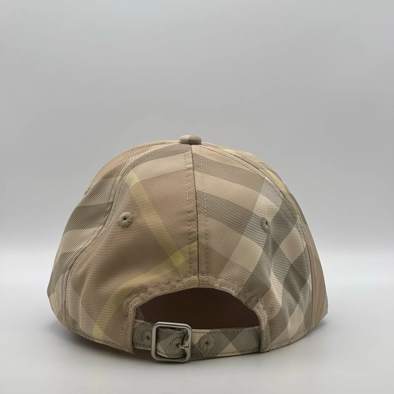 Pale beige check Burberry cap, back view showing the metal buckle strap.