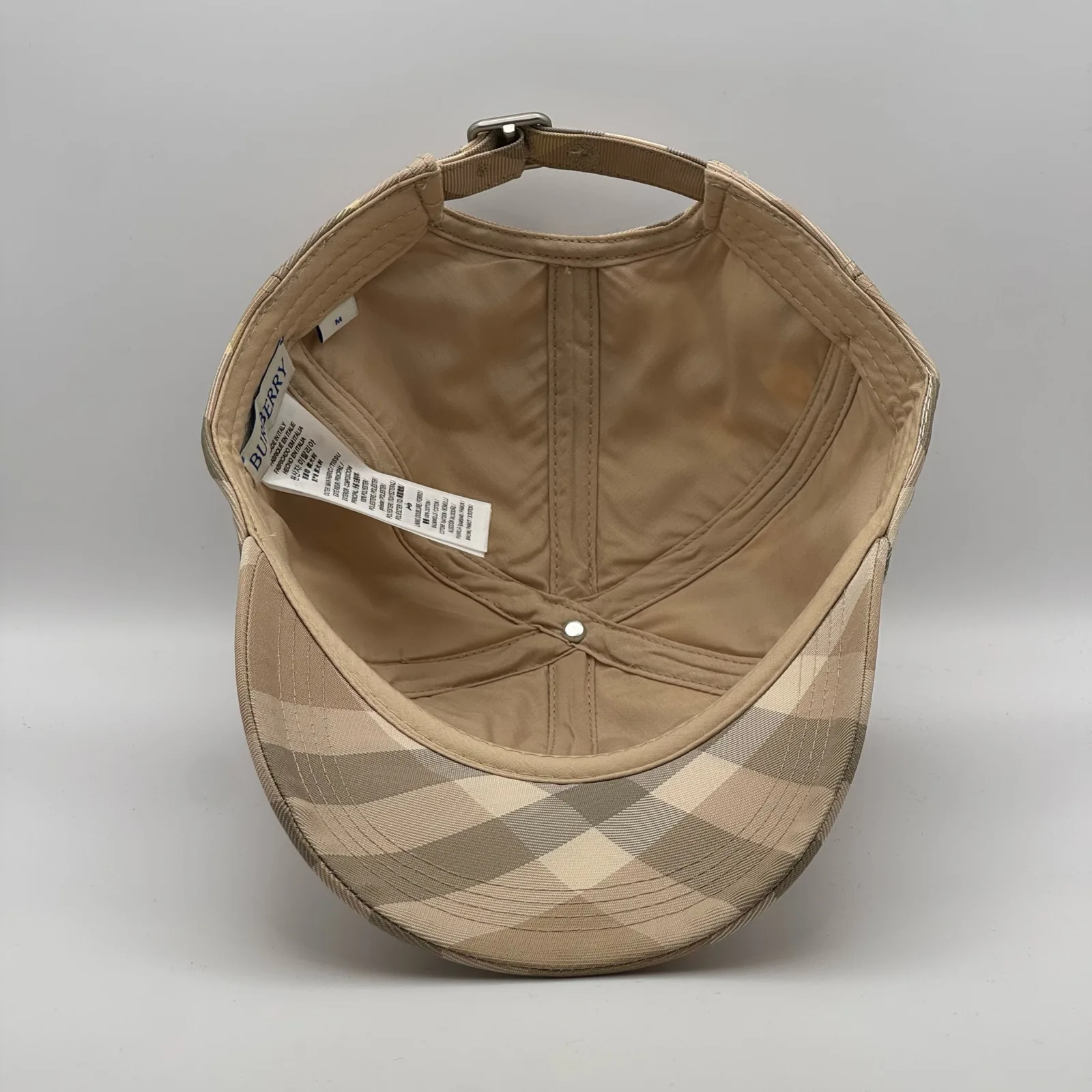 Interior of the pale beige check cap, looking down into the crown.