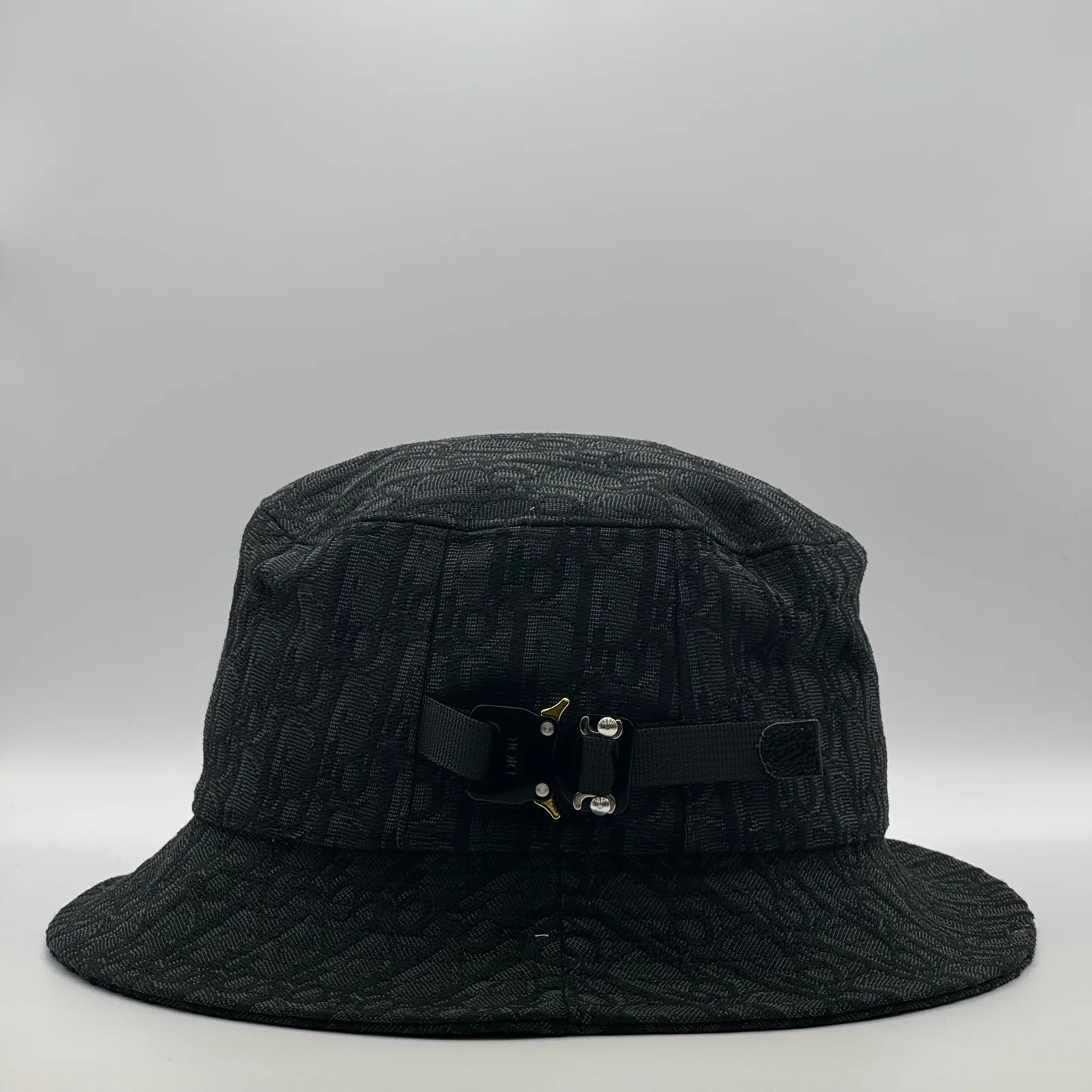 Black Dior Oblique bucket hat, side view showing the buckle strap.