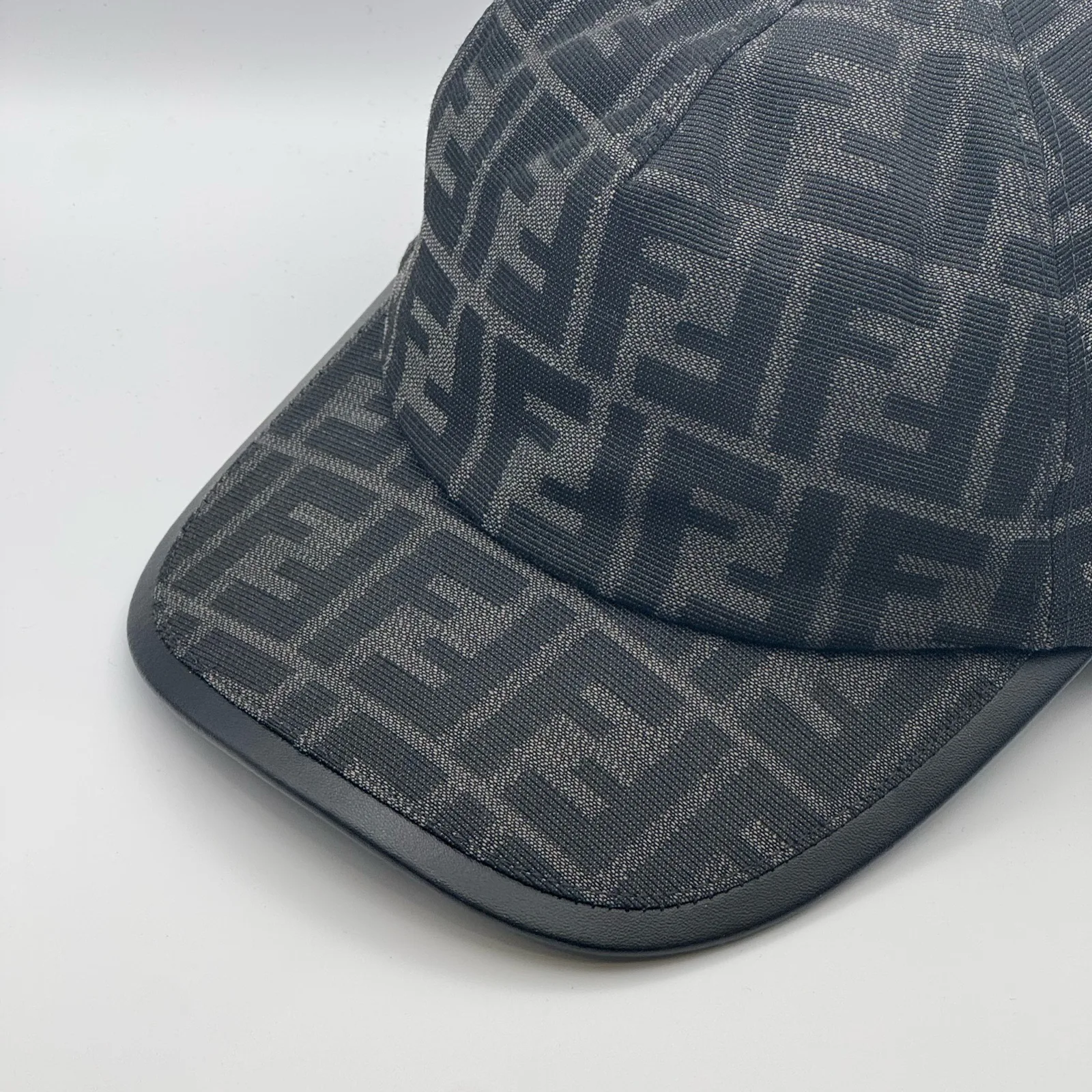 Close-up of the tonal brim edge on the black-on-black FF cap.