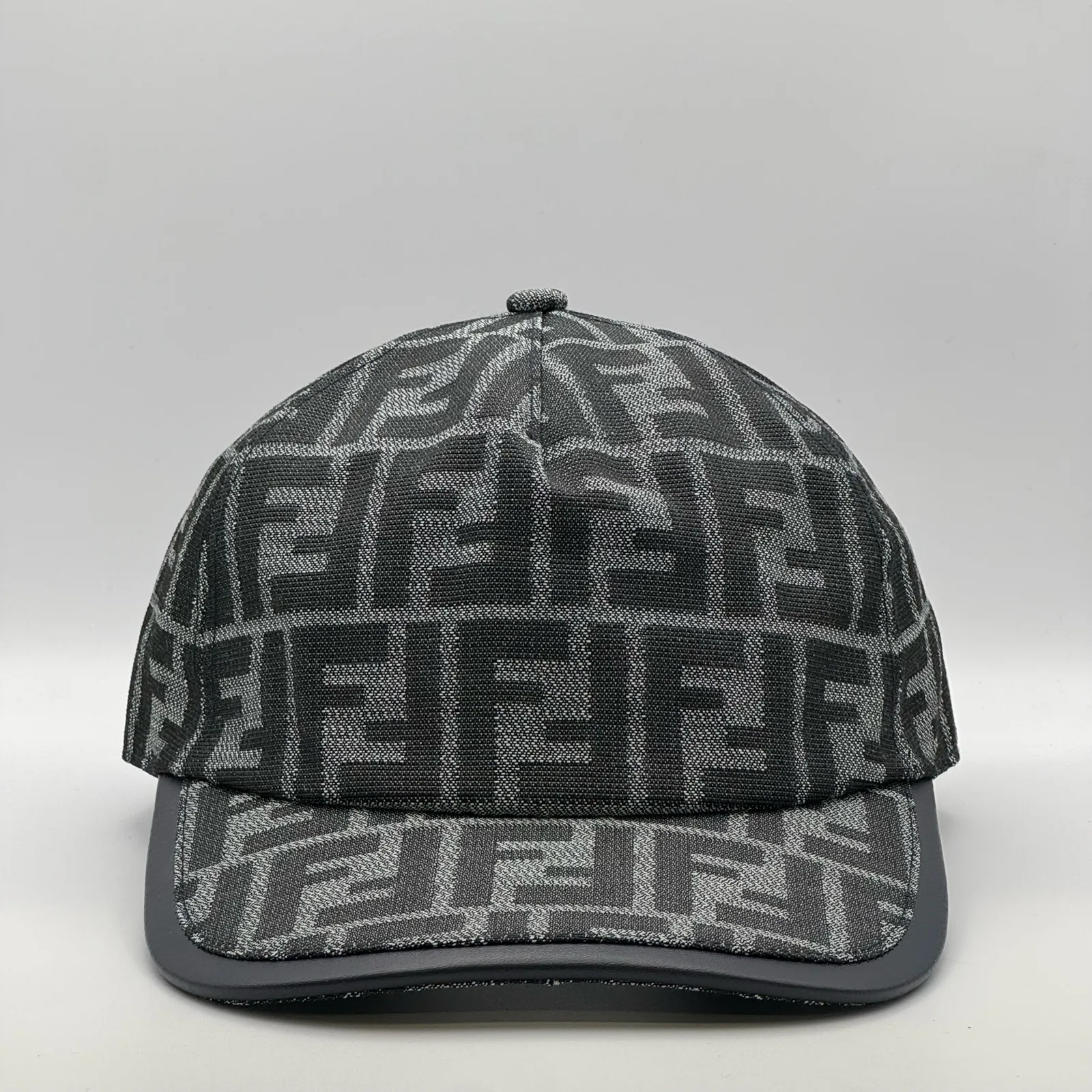 Charcoal grey Fendi FF cap, three-quarter front-left view.