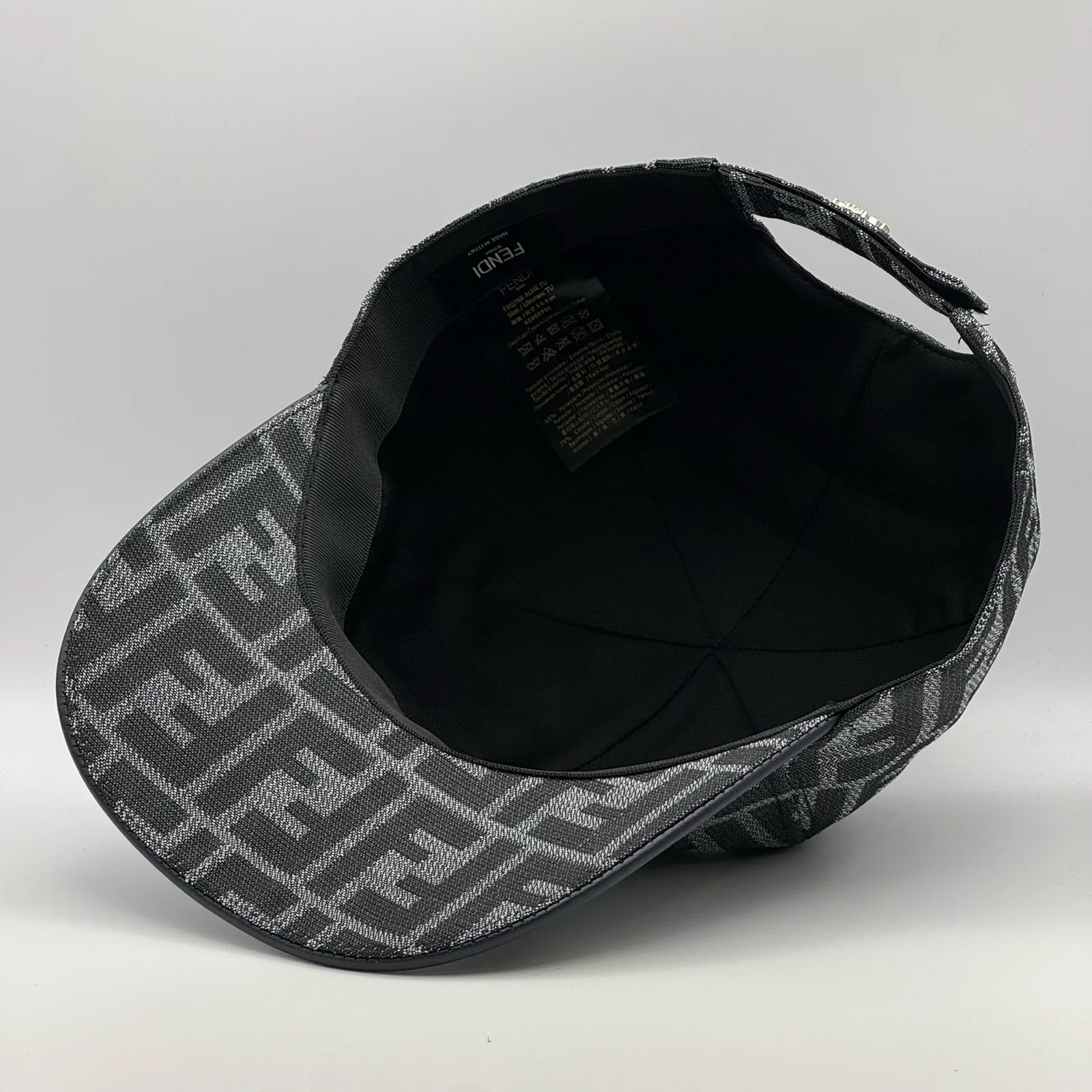 Underside of the charcoal grey FF cap, brim lifted to show the black interior.