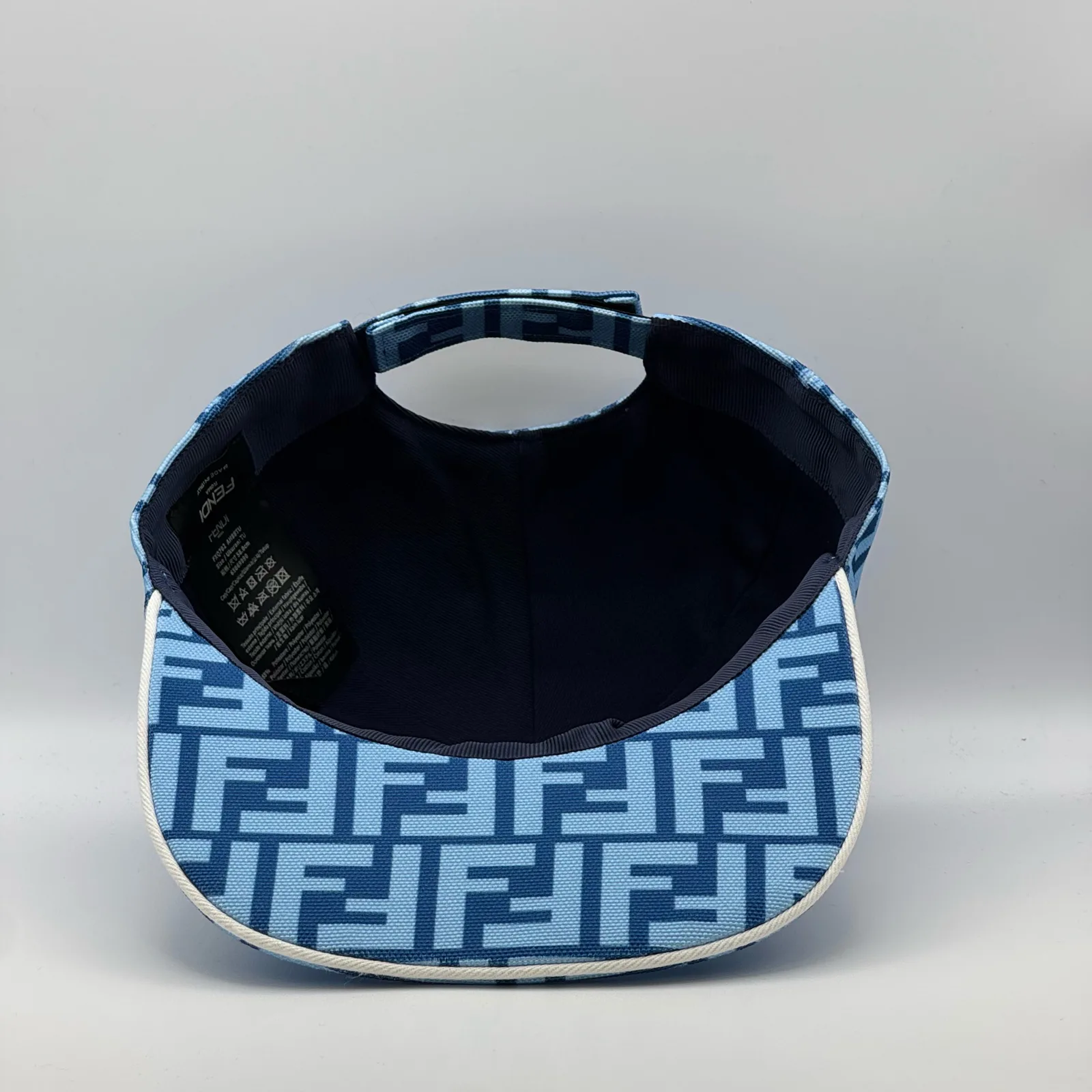 Underside of the light blue FF cap, brim lifted to show the navy interior.