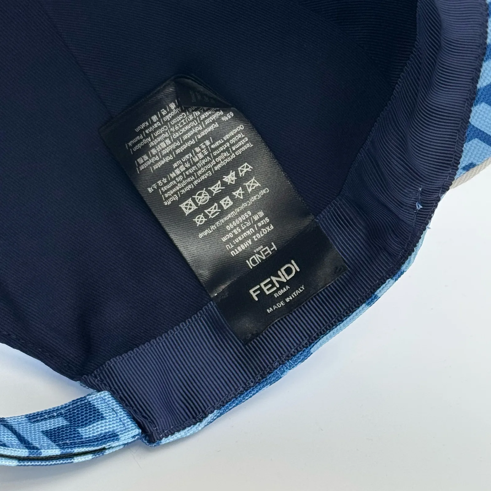 Close-up of the Fendi brand tag inside the light blue FF cap.