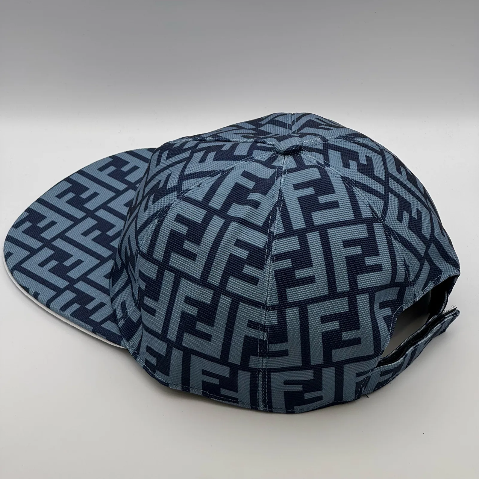 Navy blue Fendi FF cap, elevated three-quarter view of the crown.