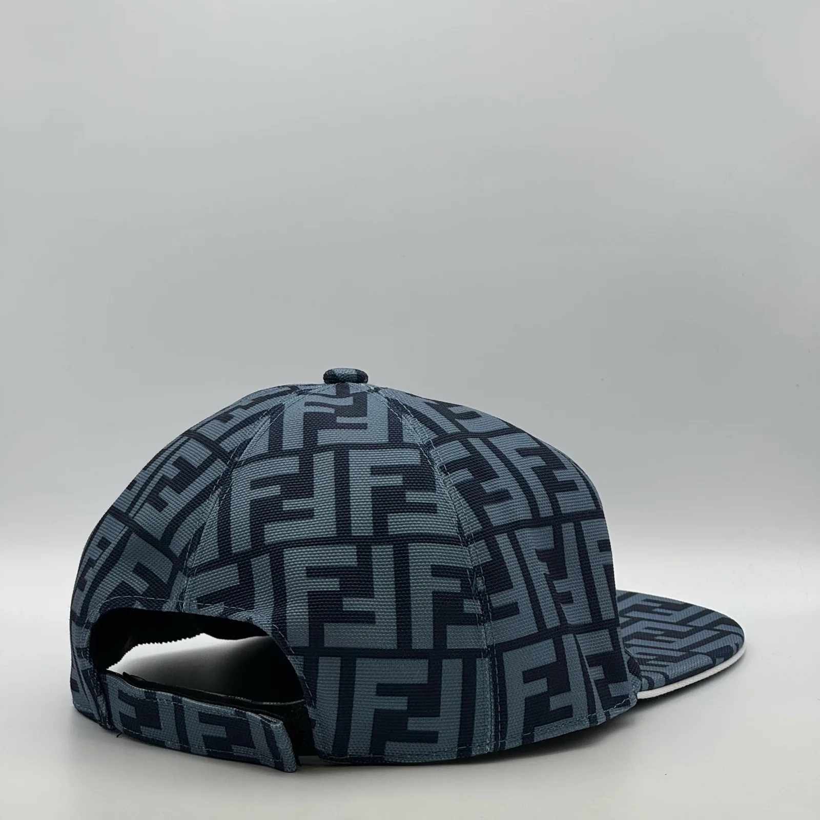 Close-up of the strap closure at the back of the navy blue FF cap.