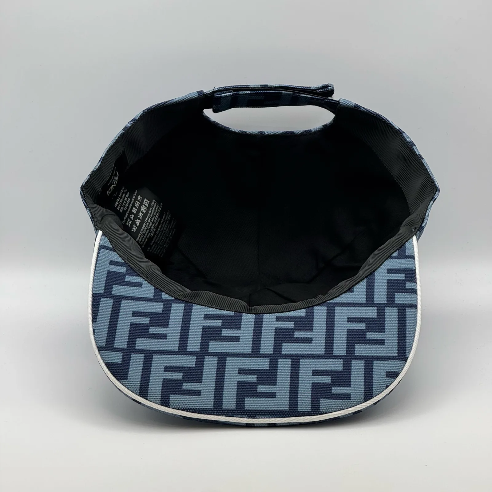Underside of the navy blue FF cap, brim lifted to show the black interior.