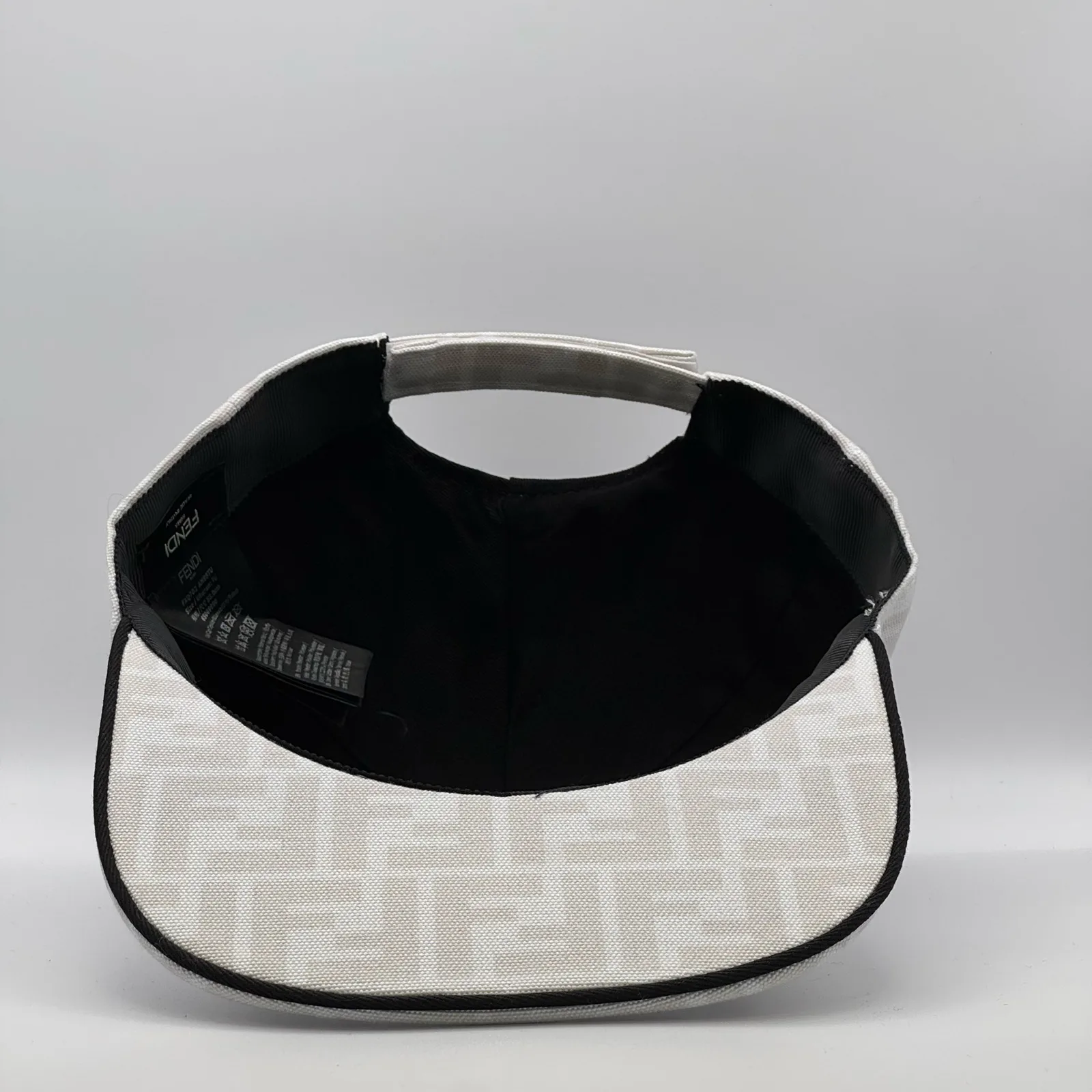 Underside of the white FF cap, brim lifted to show the black interior.