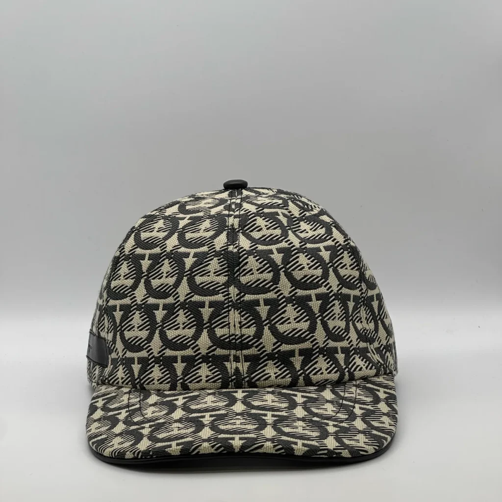 Ferragamo Gancini cap, front view in cream and charcoal weave with a black trim.