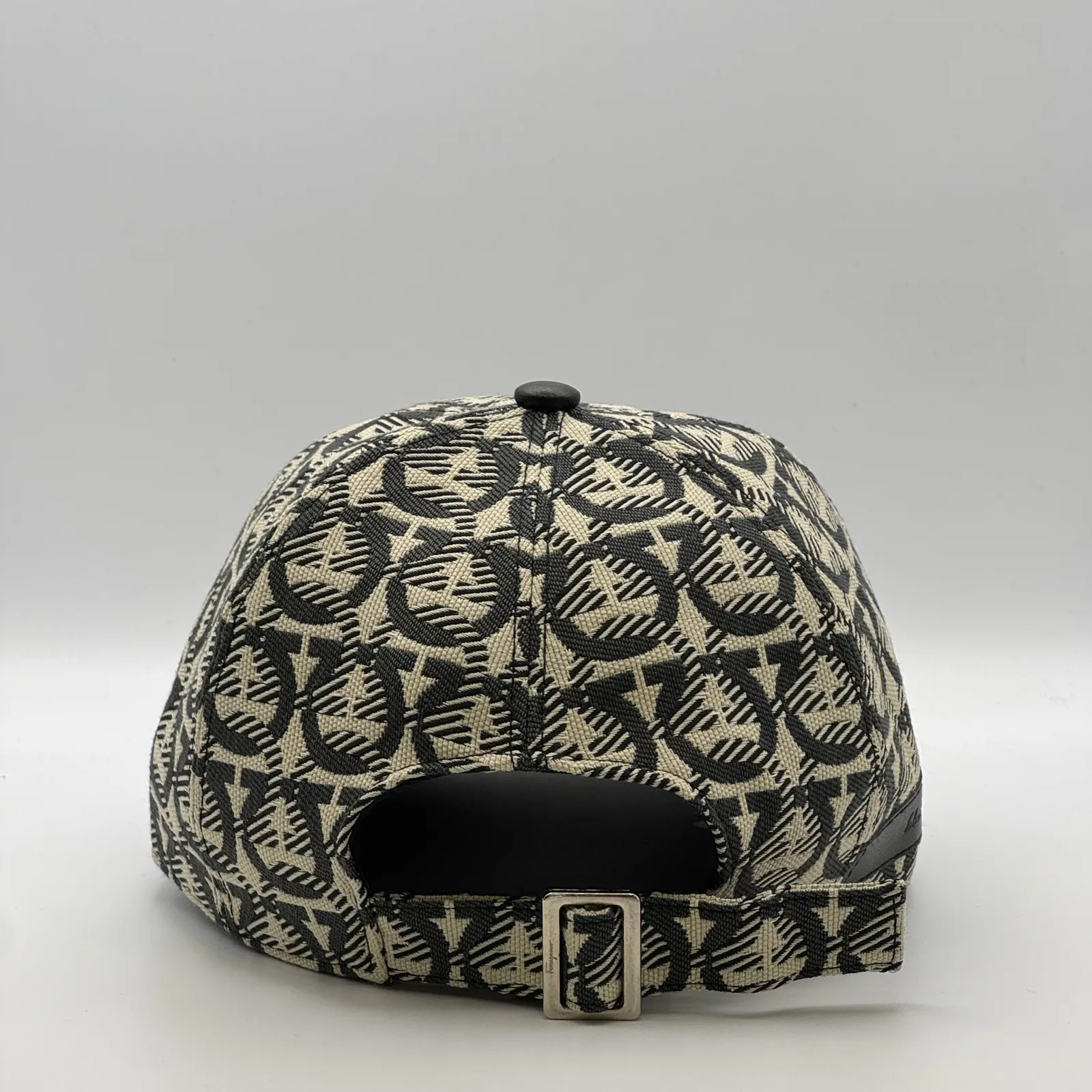 Ferragamo Gancini cap, back three-quarter view showing the engraved metal buckle.