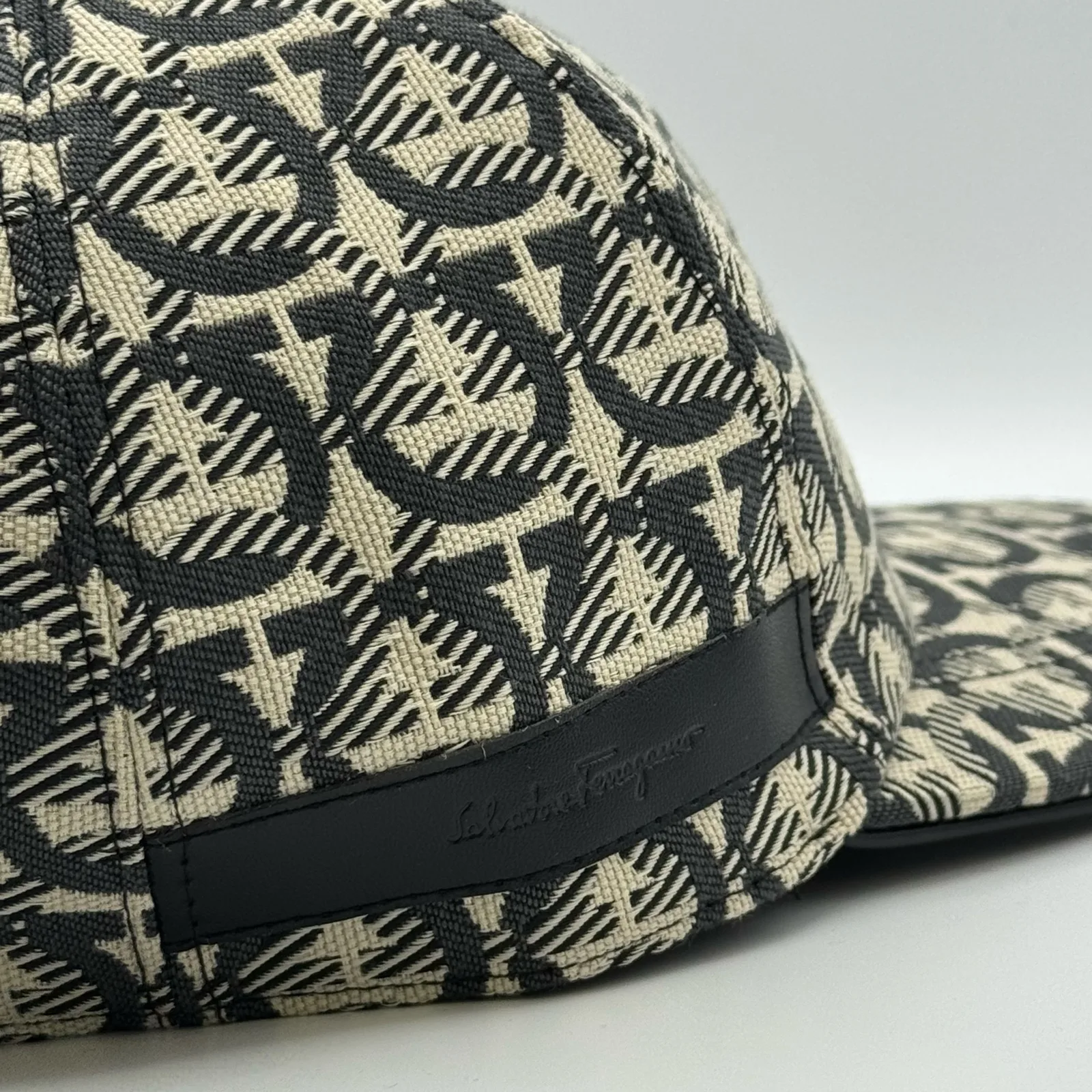 Close-up of the black edge trim and woven brand label near the brim.