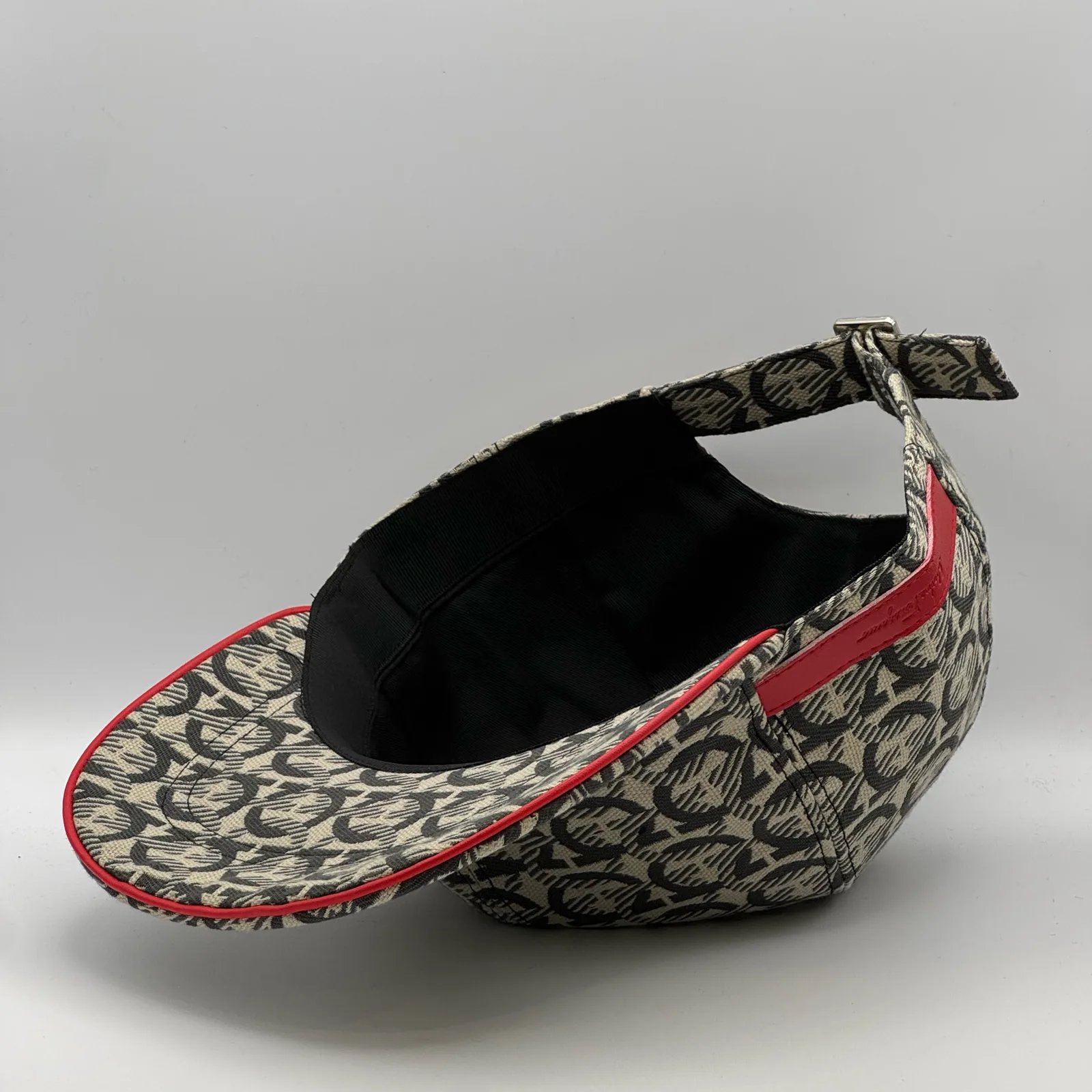 Close-up of the strap and brand tag inside the crown, cap tipped on its side.