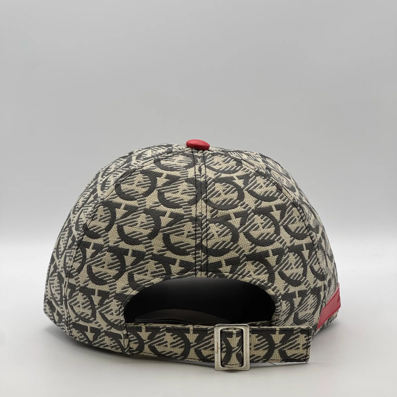 Ferragamo Gancini cap, back three-quarter view showing the engraved metal buckle.
