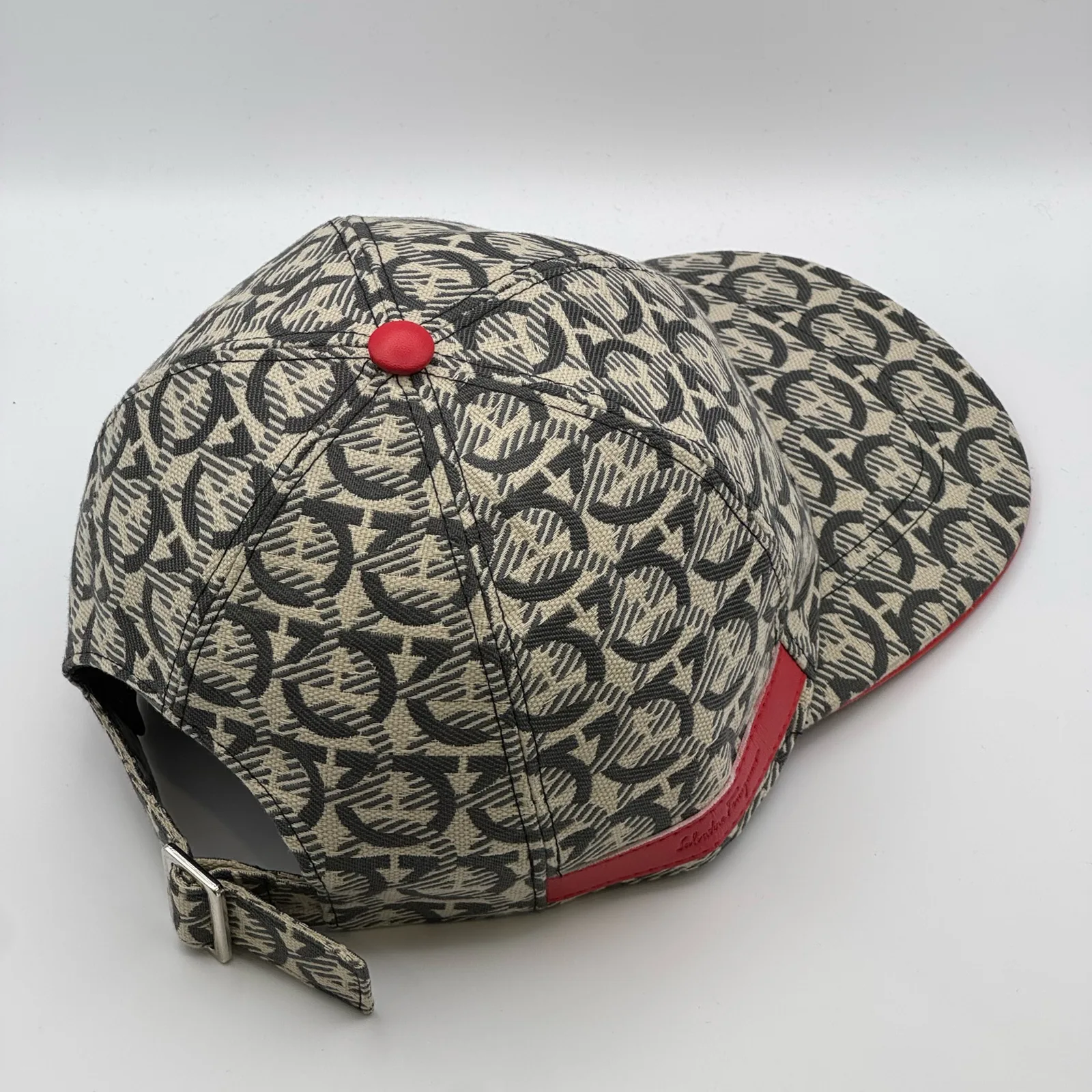 Ferragamo Gancini cap, rear side view showing the strap tab hanging free.