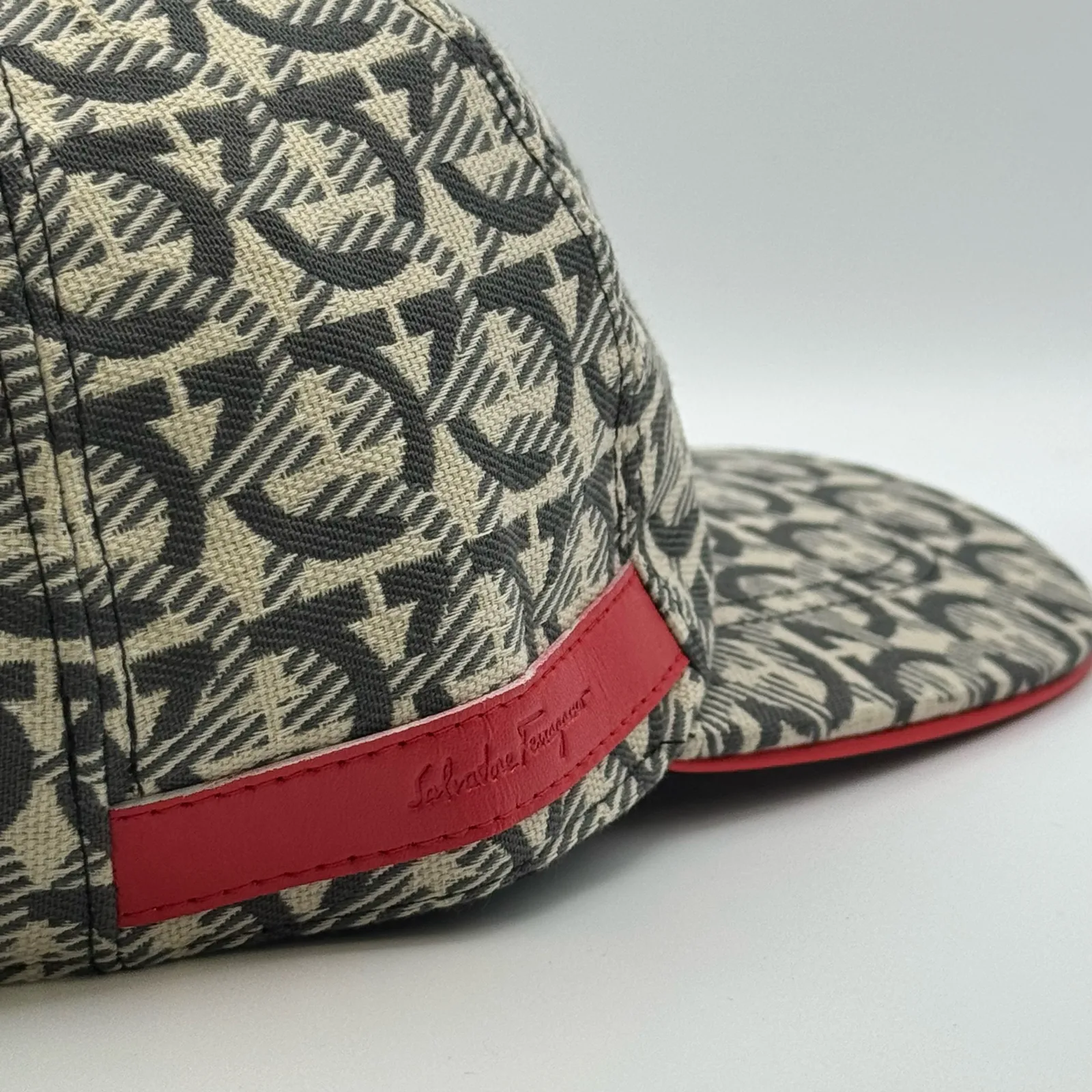 Close-up of the red edge trim and woven brand label near the brim.