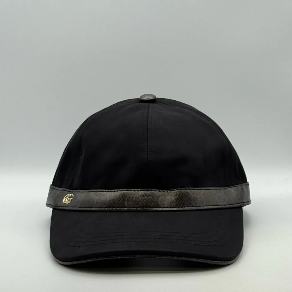 Black cap with GG canvas brim trim and gold-tone logo, front view