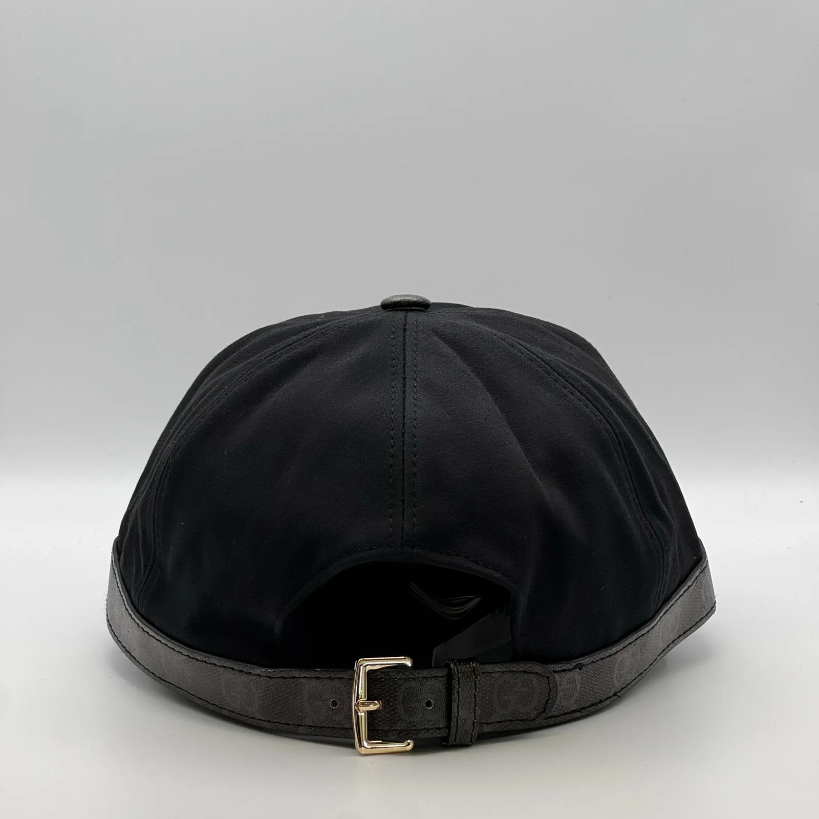 Black GG band cap, back view with leather strap and buckle