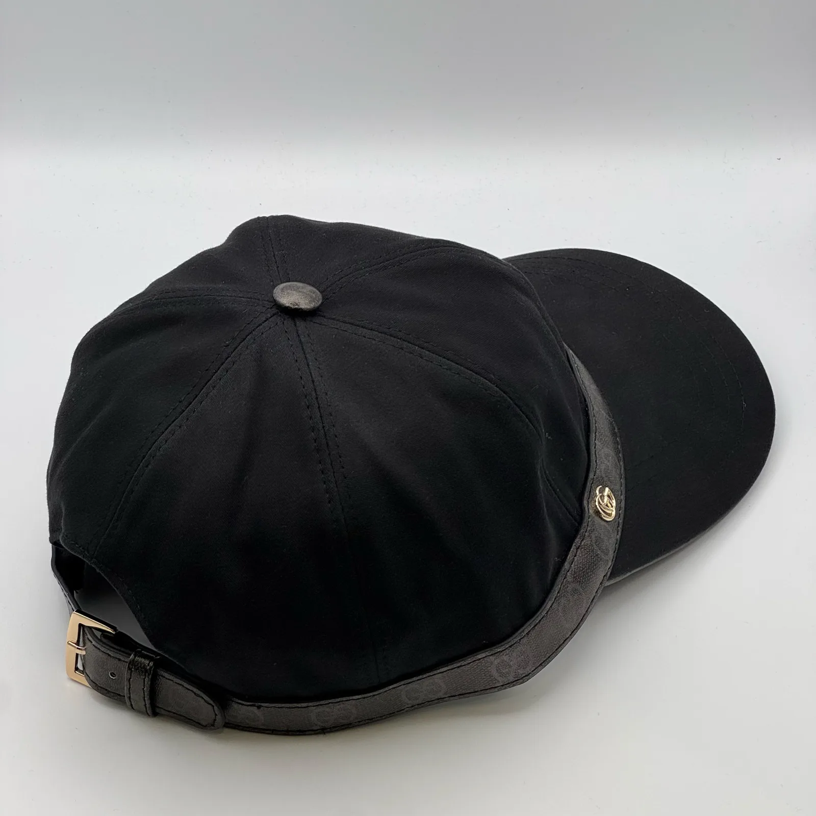 Black GG band cap, back three-quarter view showing strap tab