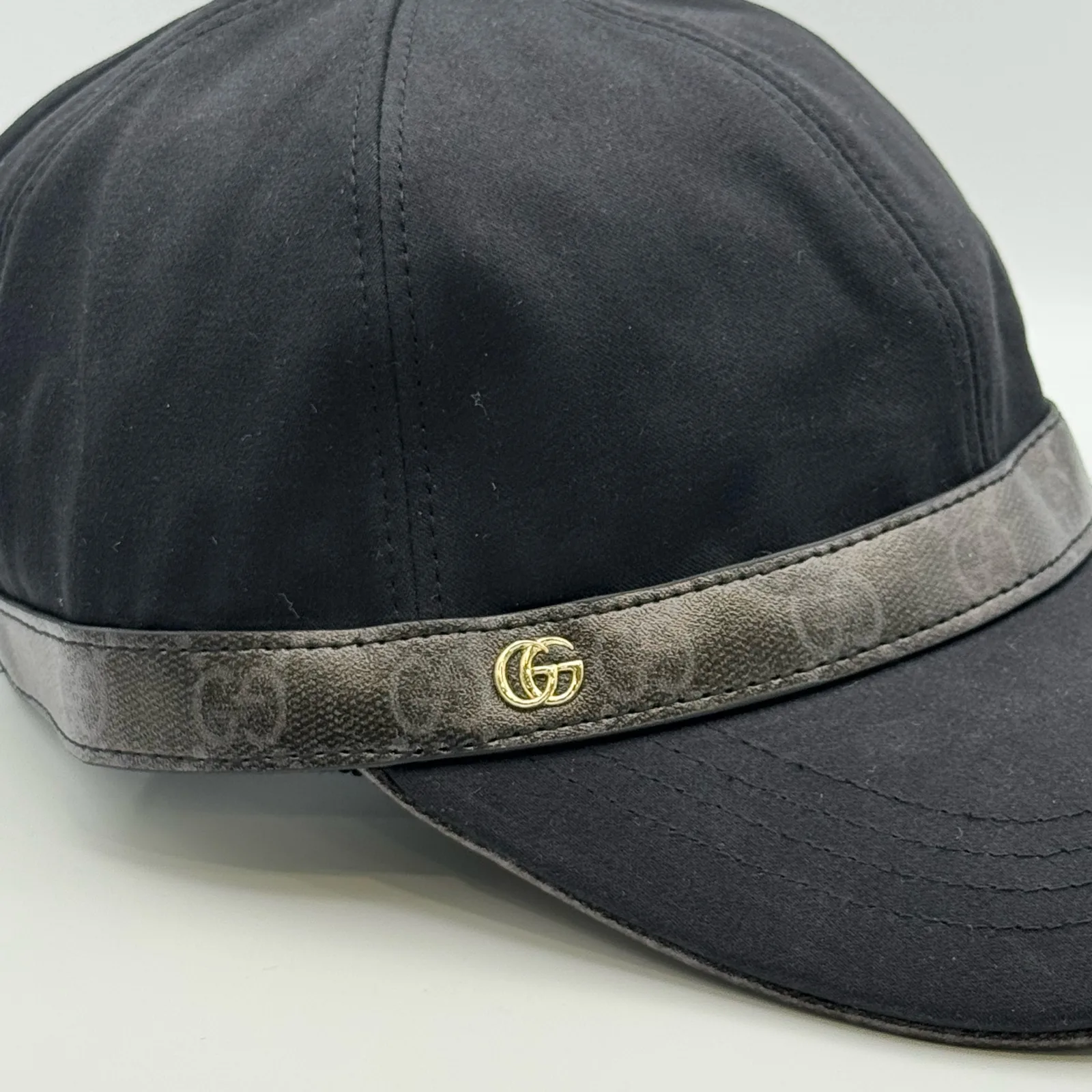 Close-up of GG canvas brim band and gold-tone logo