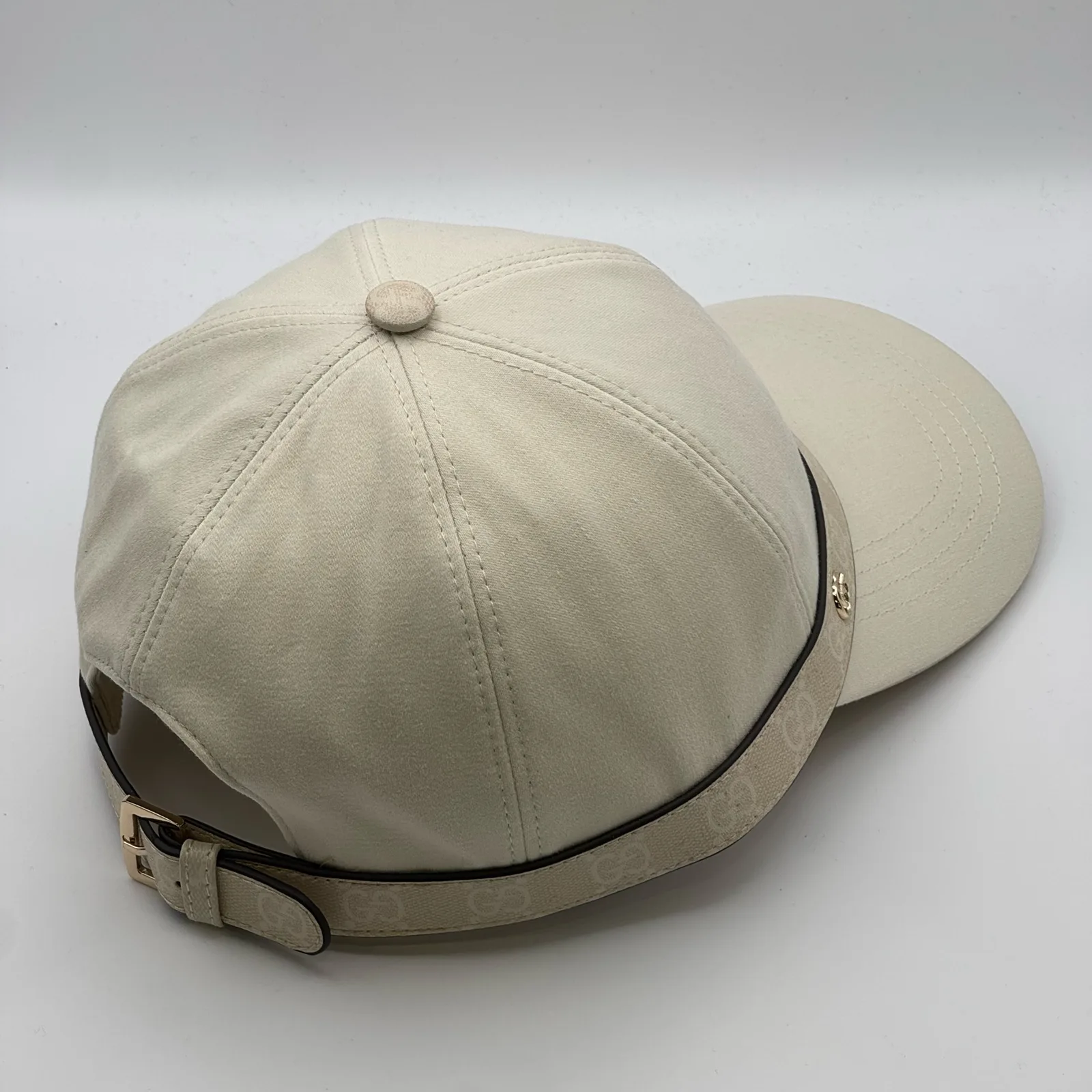 Cream GG band cap, back three-quarter view showing strap tab