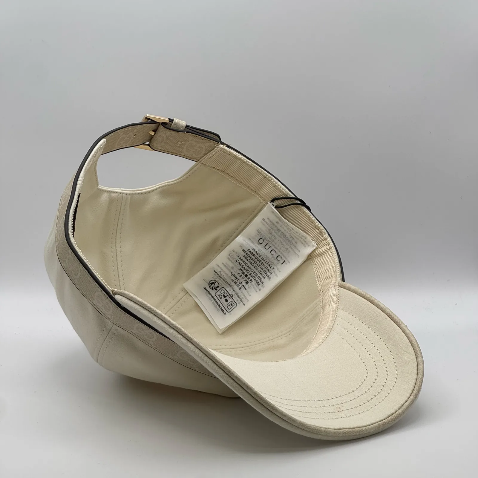 Cream GG band cap interior, close view of underbrim and care label