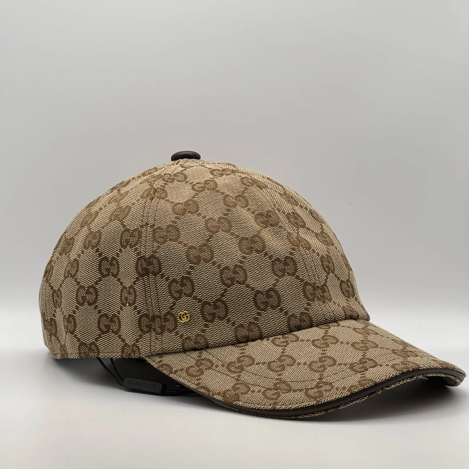 Beige GG canvas cap, side view showing the brown leather brim and strap
