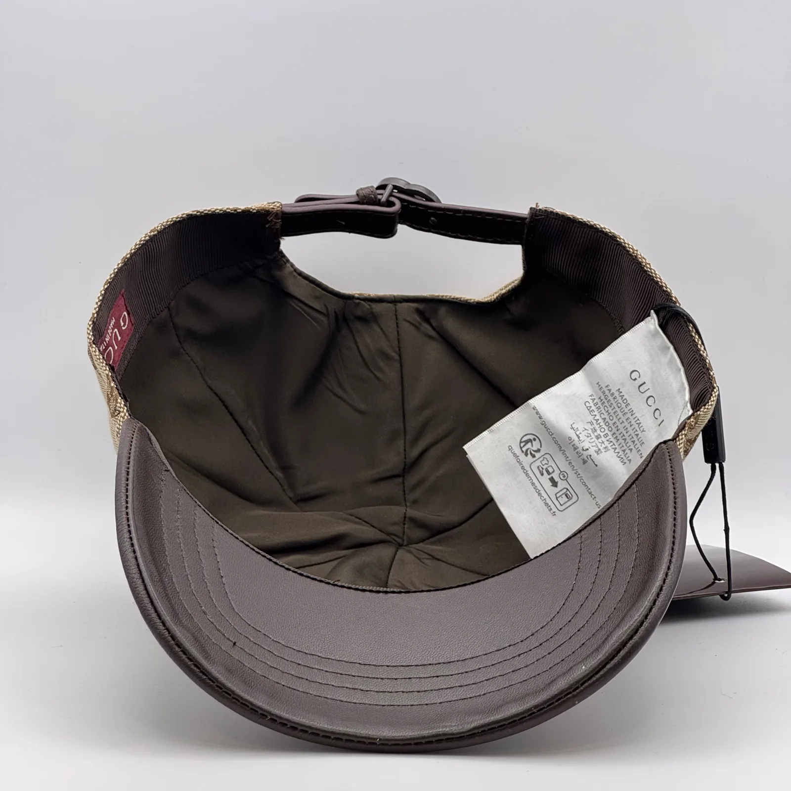 Beige GG canvas cap, interior view showing the brown lining and hanging tag