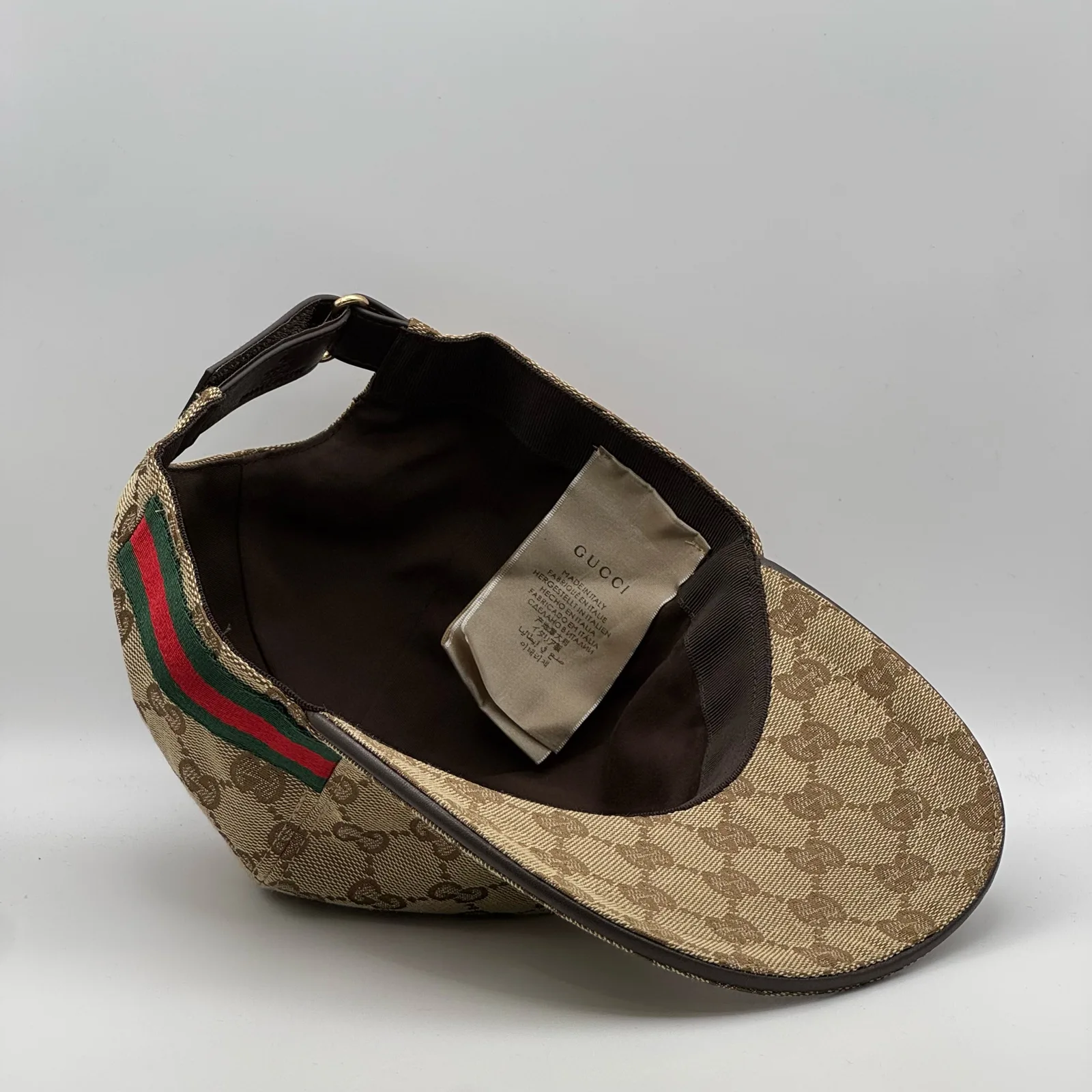 Beige GG canvas cap, interior view with brand tag and strap detail