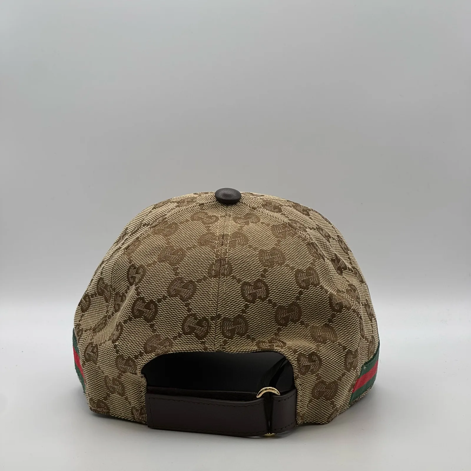 Beige GG canvas cap, back view with dark brown leather strap and buckle