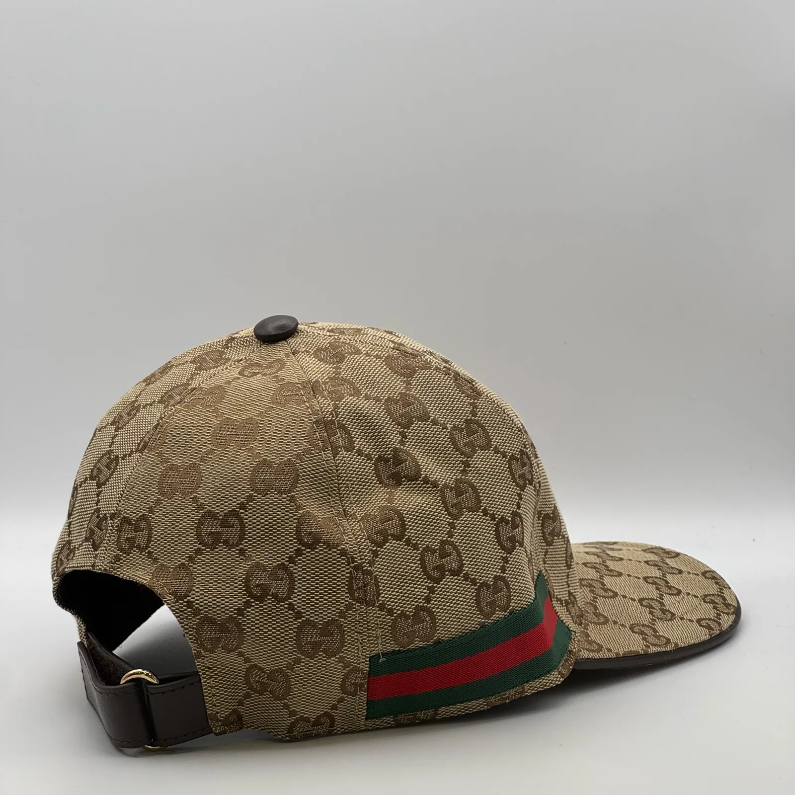 Beige GG canvas cap, side view showing the brim and adjustable strap