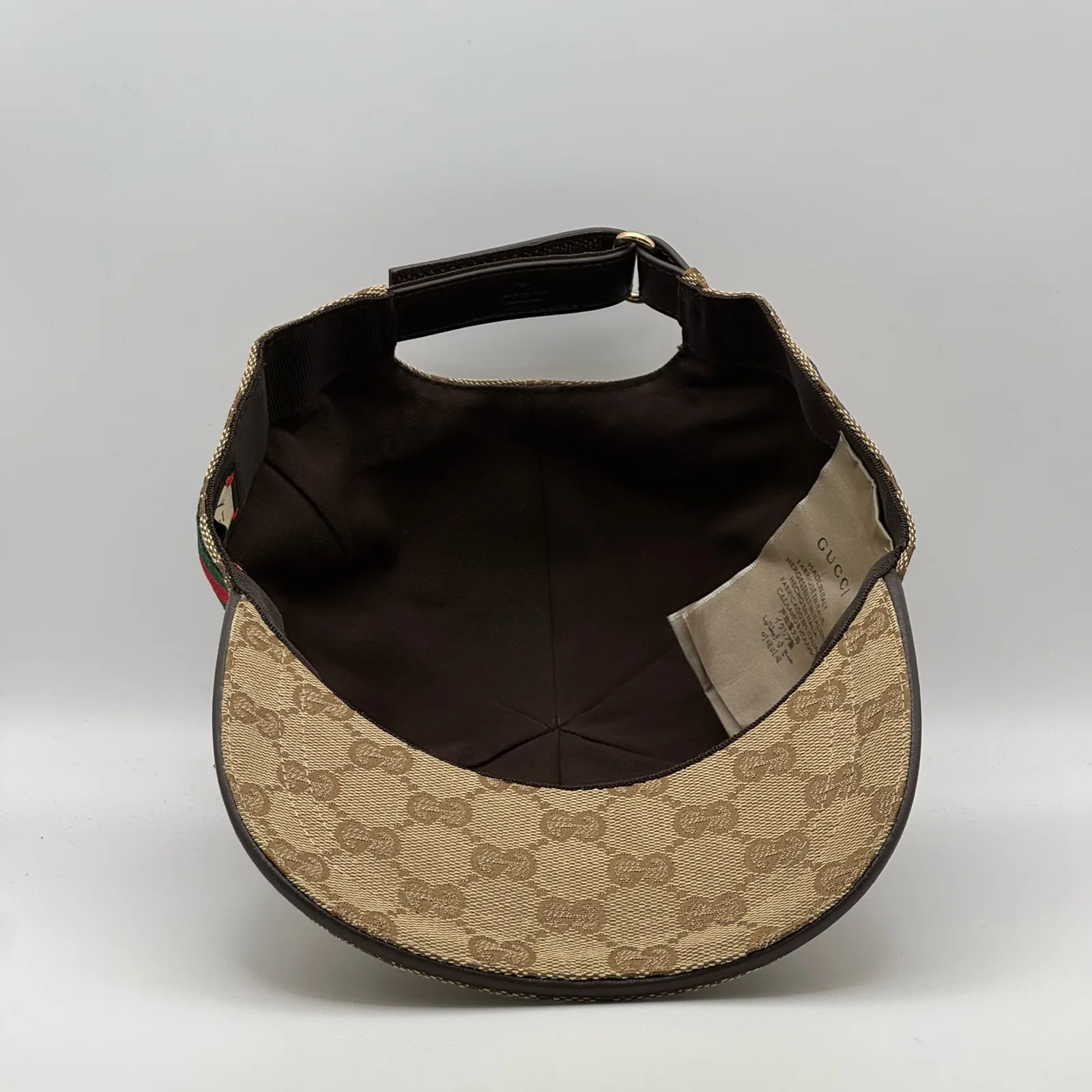 Beige GG canvas cap, interior view showing the brown lining and brand tag