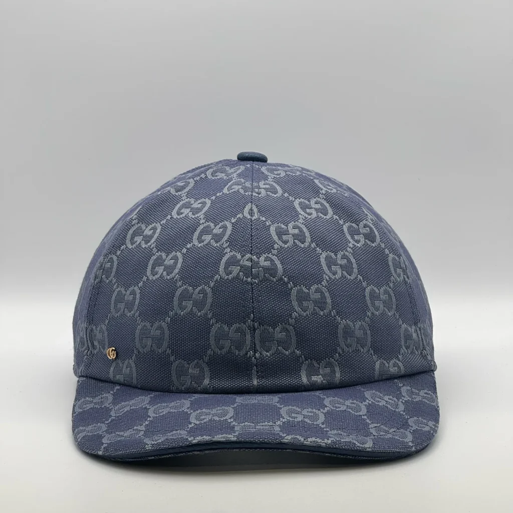 Denim blue GG canvas cap, front three-quarter view with a subtle tonal pattern