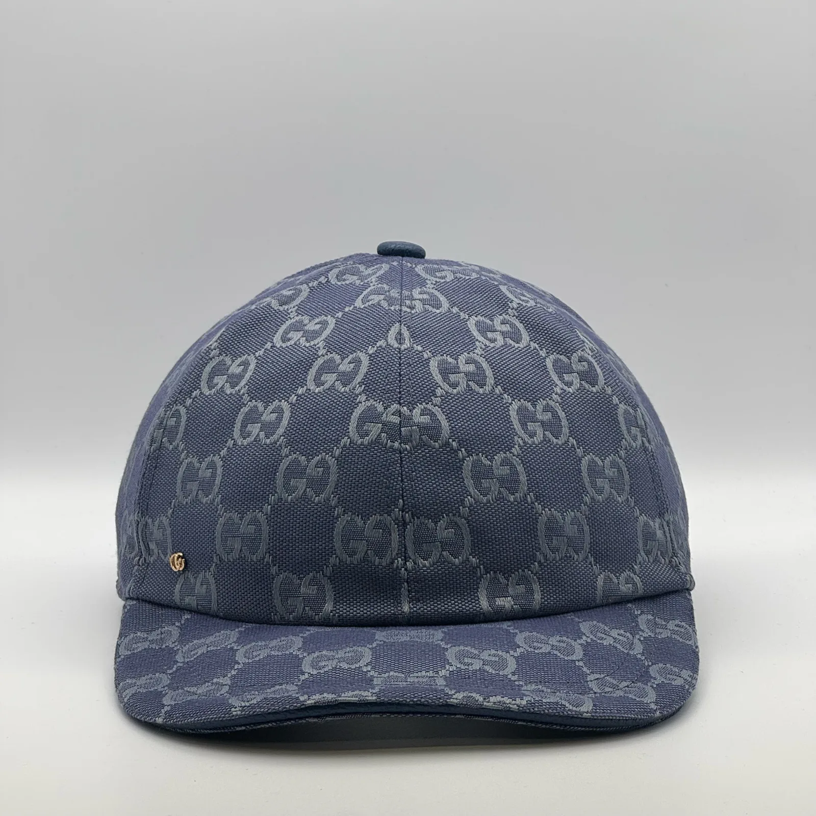 Denim blue GG canvas cap, front three-quarter view with a subtle tonal pattern