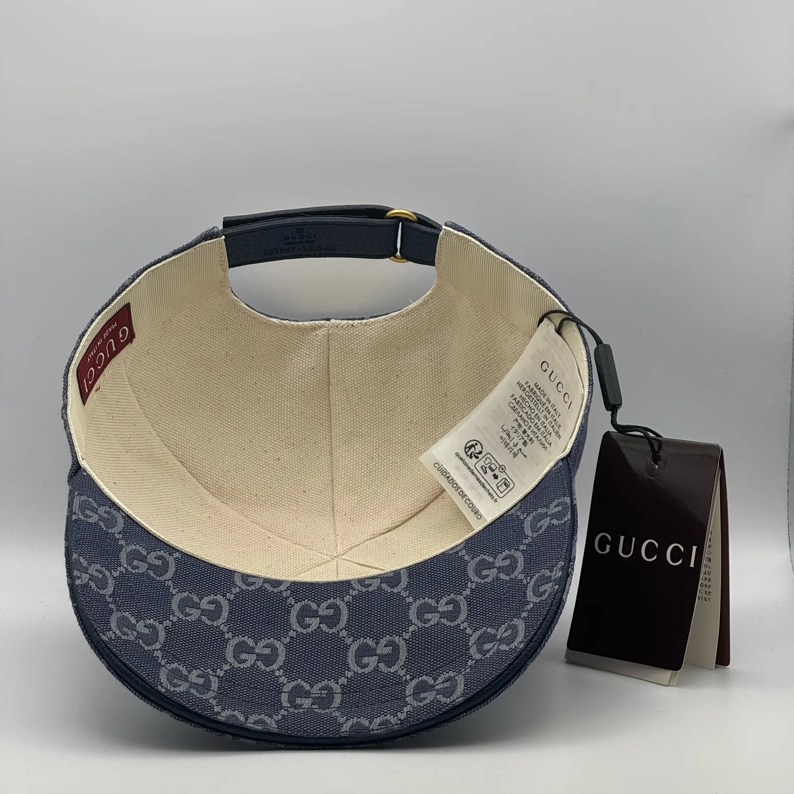 Denim blue GG canvas cap, interior view with brand booklet and tag