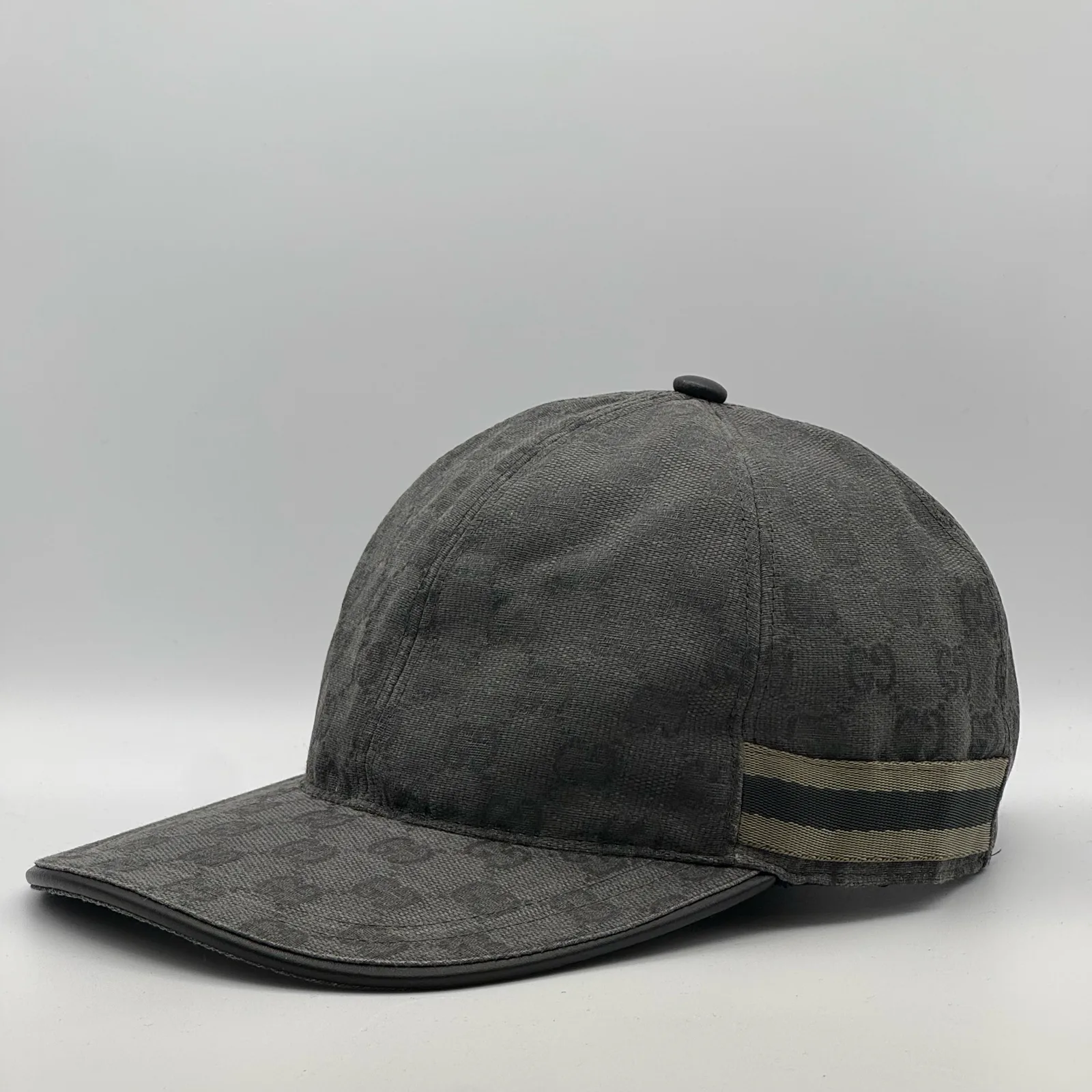 Charcoal grey GG canvas cap, side view showing the web stripe trim