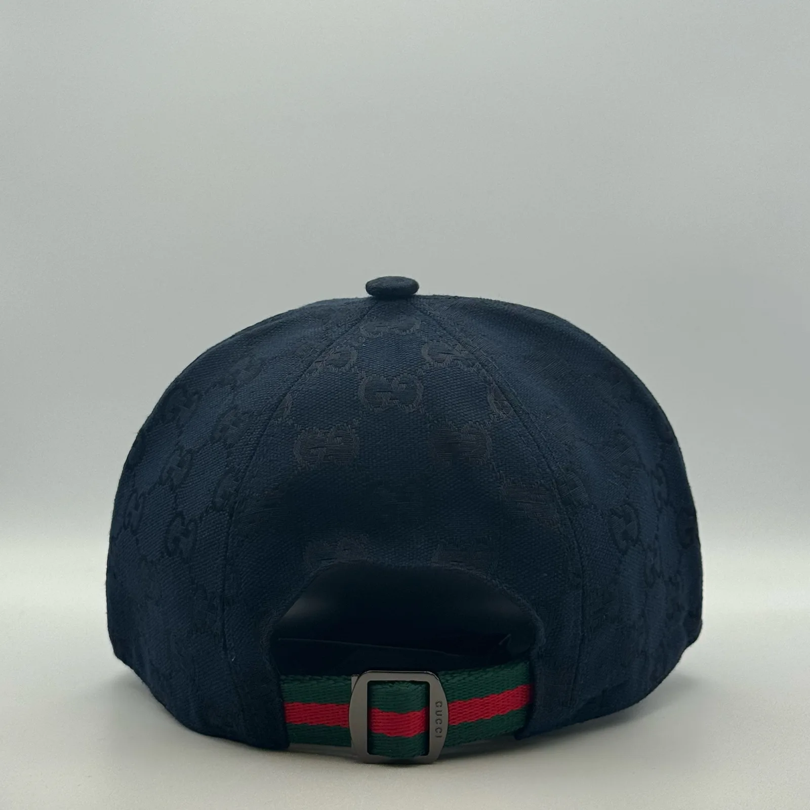 Navy GG canvas cap, back view with green and red web stripe strap