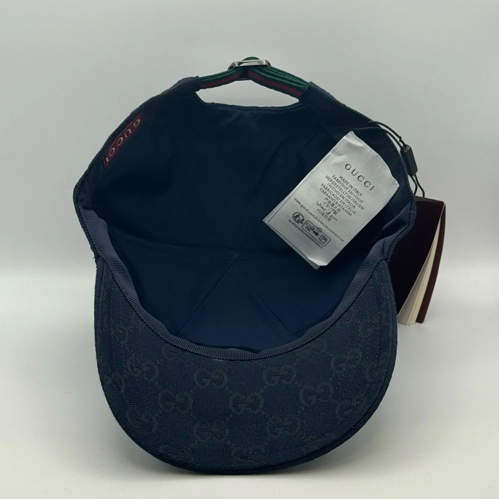 Navy GG canvas cap, interior view with brand booklet and tag