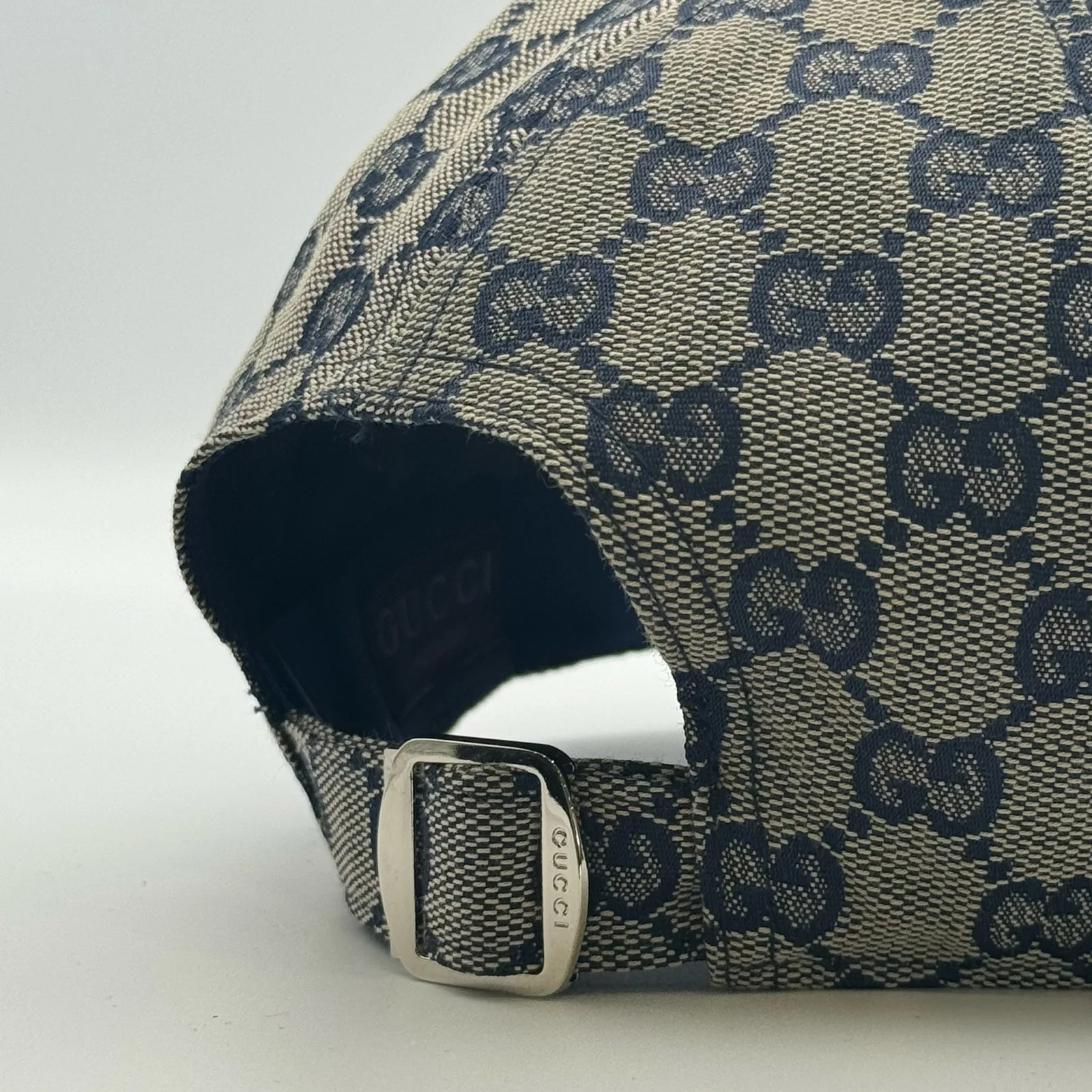 Navy and beige GG canvas cap, underside view showing the navy interior lining