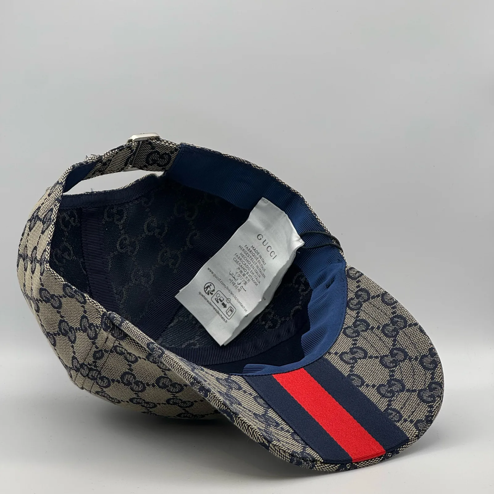 Navy and beige GG canvas cap, interior view showing the red web stripe strap
