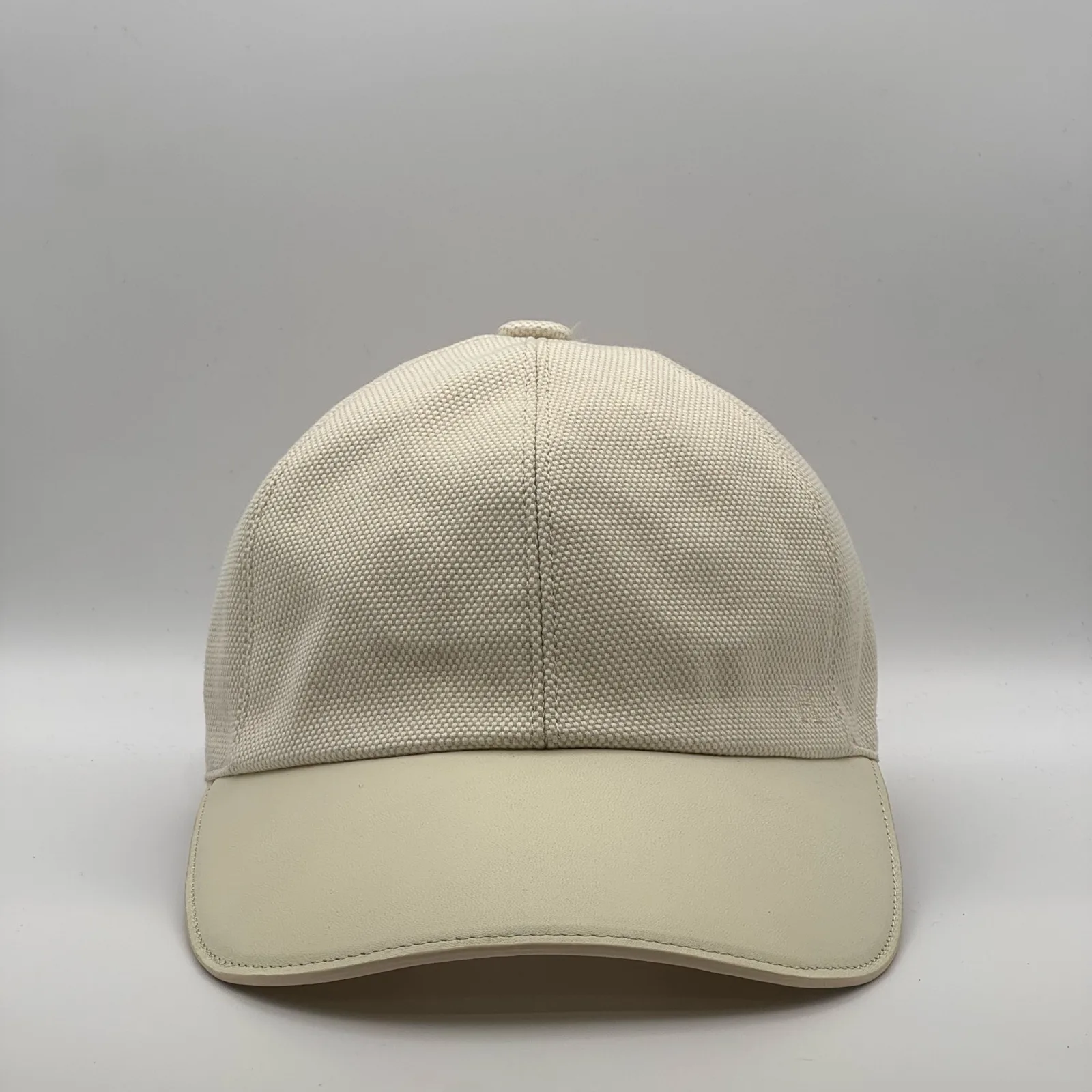 Hermès canvas cap, front view in an all-cream colourway with a matching leather brim.