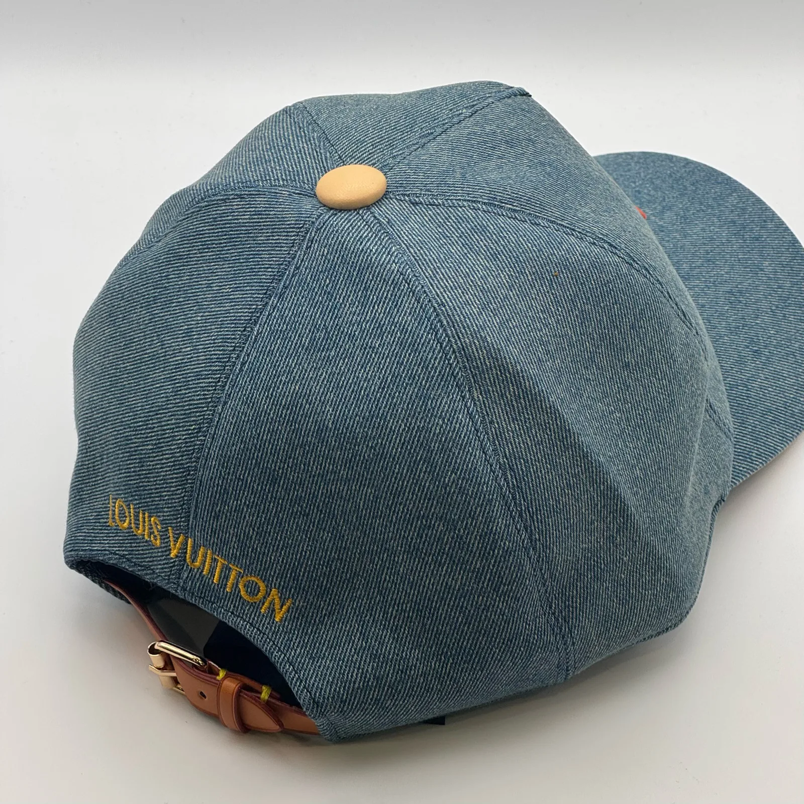 Blue denim flower cap, three-quarter back view.