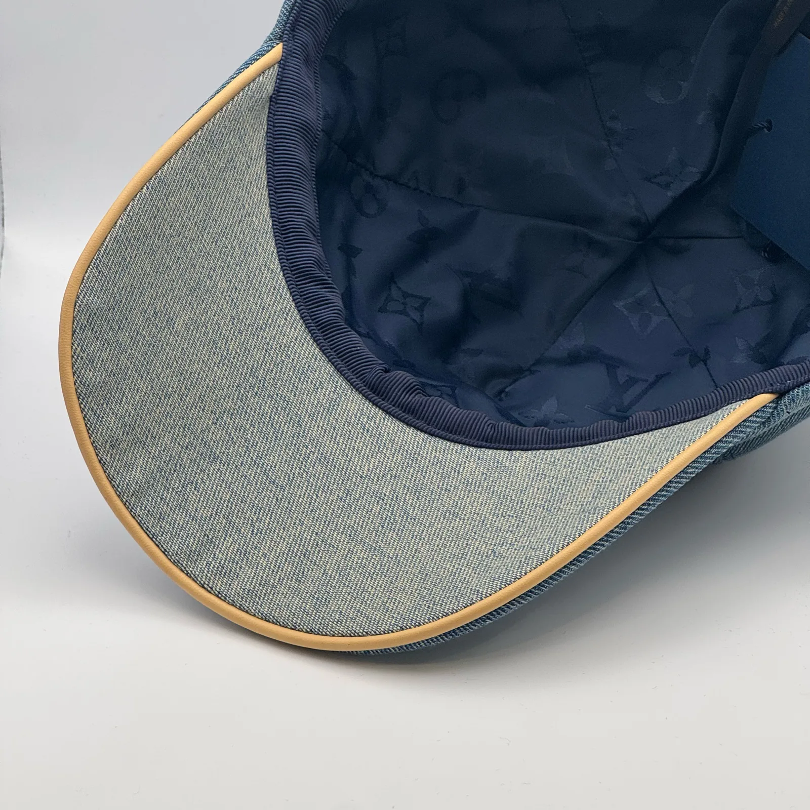 Close-up of the tan leather piping along the brim edge.