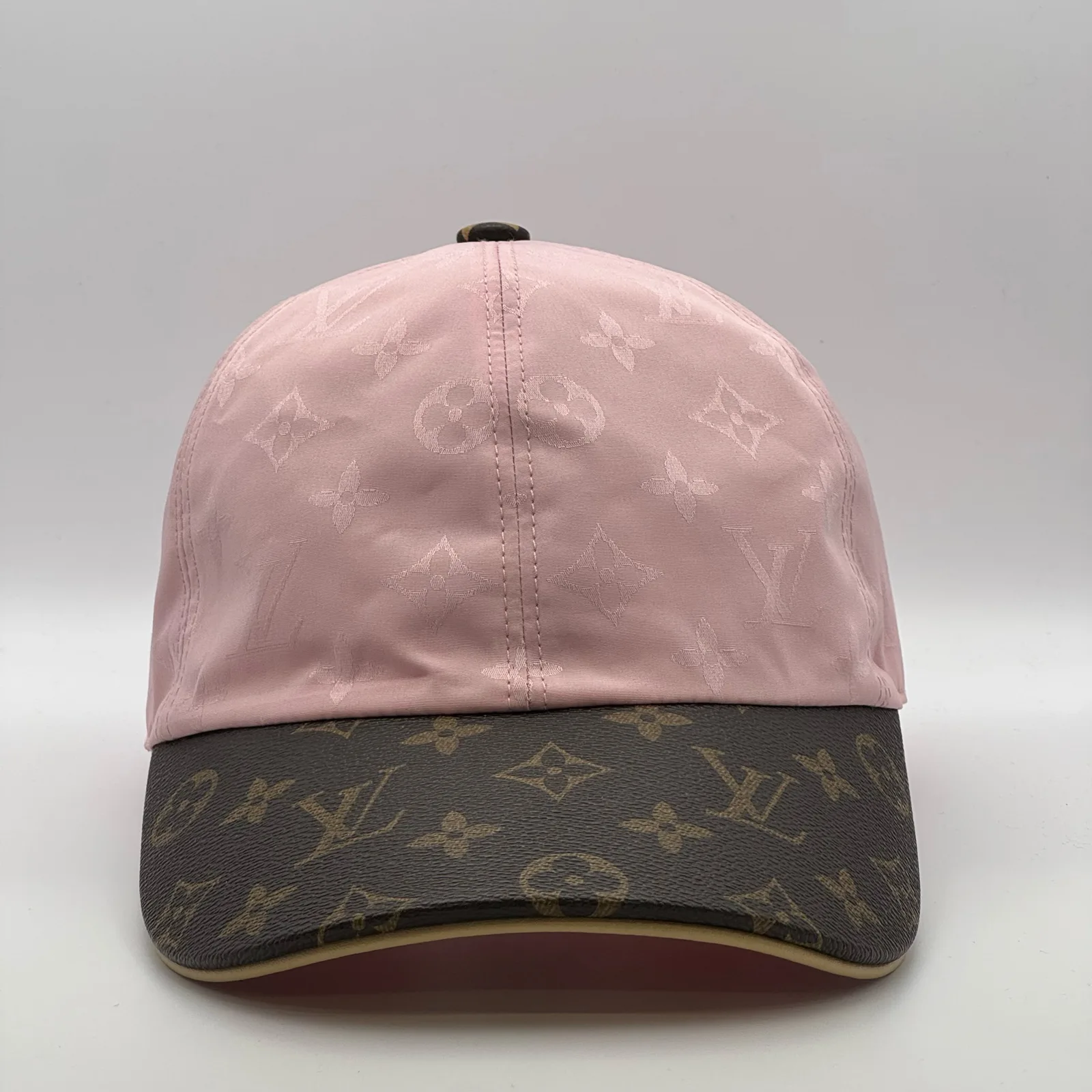 Pink Louis Vuitton Monogram Brim cap, three-quarter view showing the monogram canvas brim.