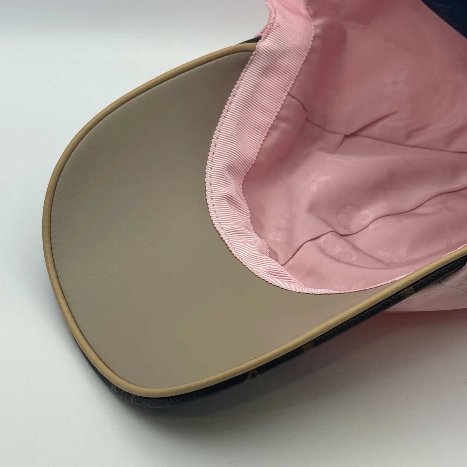 Underside view of the pink cap showing the interior crown.