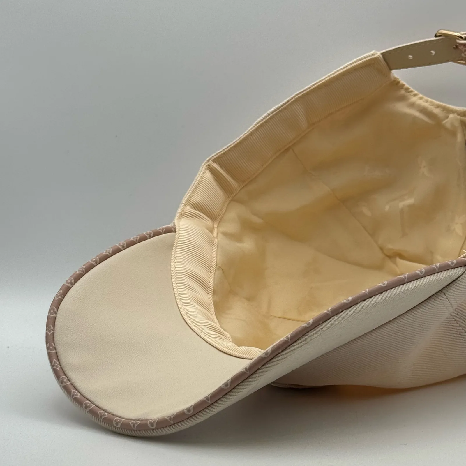 Close-up of the underbrim and leather trim on the beige flower cap.