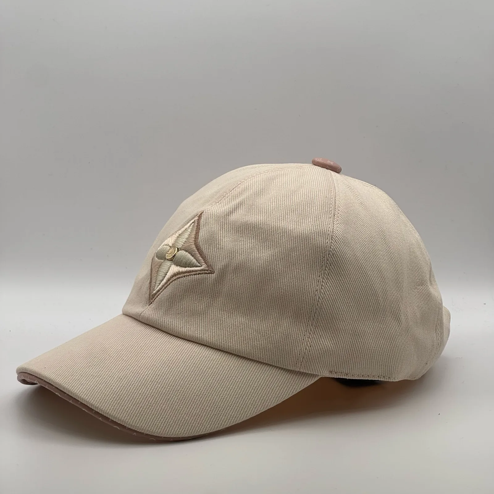 Beige flower cap, opposite side profile view.